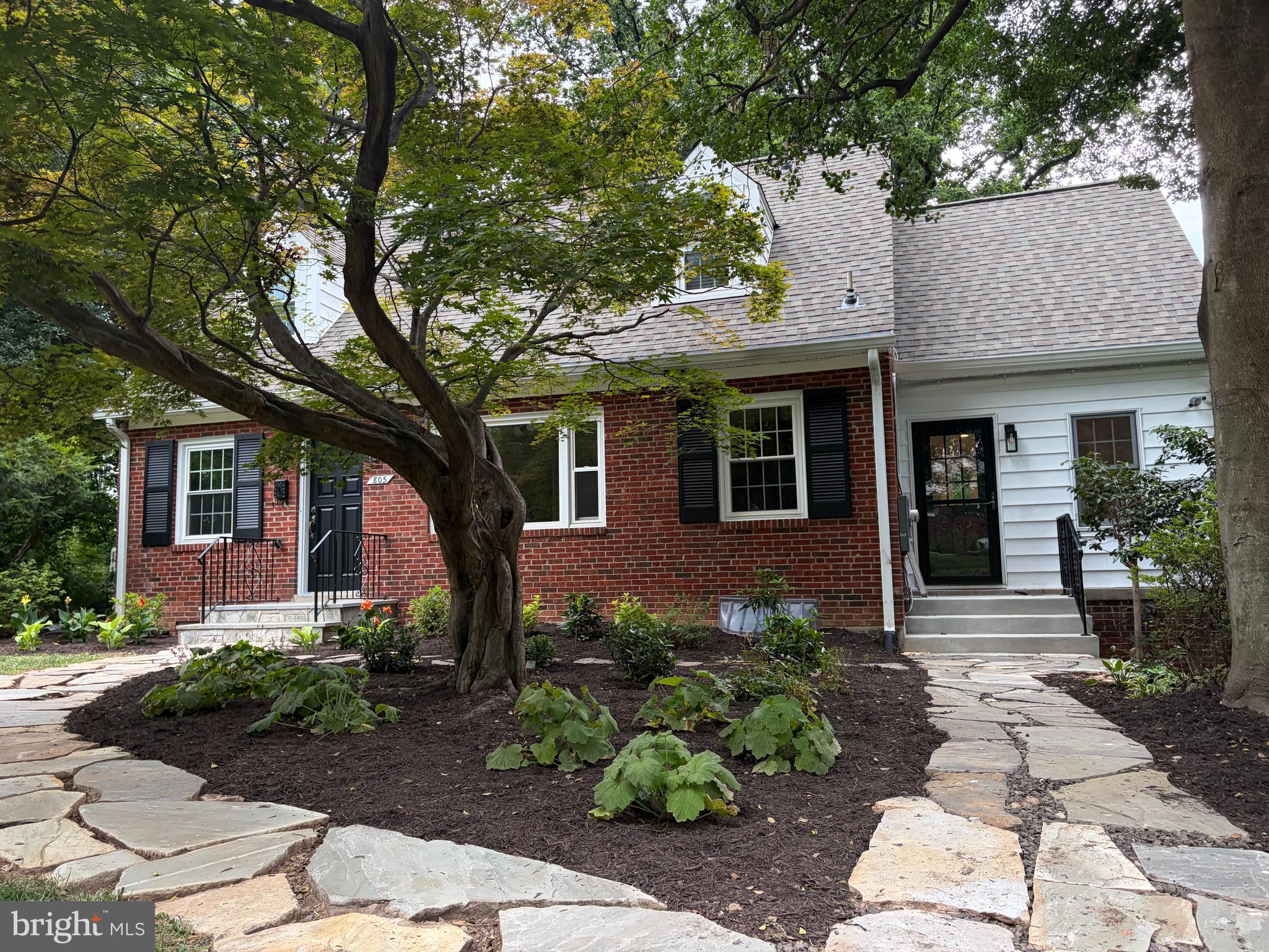 Tucked away on a quiet cul-de-sac in the desirable Broadmont section of Falls Church City, this charming 3-bedroom + den, 3-bath Cape Cod sits on a spectacular, private 1/3+ acre lot less than a mile from the East Falls Church Metro. Mature trees and beautiful backyard views create a treehouse-like setting, offering a peaceful retreat with easy access to DC, a 15-min drive to the Pentagon, and major commuter routes. The school bus to any of the highly rated FCC schools conveniently stops on the nearby corner. It boasts a walking score of 80, close to restaurants (like the foodie haven of Eden Center), shops and bike paths.

The current owners thoughtfully opened the kitchen and dining area to install an island , and create a more functional, connected living space. A distinctive family room features built-in bookshelves, a window seat, cork flooring, and a large picture window overlooking the backyard. With its own entrance conveniently accessed from the driveway, this space offers exceptional flexibility for a home office, studio, or gathering space.
Generous-sized windows on all sides bring in lots of light. The charming living room features windows on 3 sides, crown molding, and a fireplace, and shares the same serene backyard views. A main-level bedroom or office with an en-suite full bath provides ideal guest, work-from-home, or multi-generational space. Upstairs, two oversized bedrooms (one with spacious dressing area/storage) with dormer windows overlook the green backyard and are complemented by a full bath and abundant storage. The original hardwood floors throughout the main and upper levels have been newly refinished.
The walkout lower level offers a spacious recreation room and den with new carpeting, full bath, and laundry area, providing even more flexible living space. Home has been freshly painted throughout and hardwood floors refinished. Extensive updates throughout the years include a renovated kitchen, upgraded heating and cooling systems in 2023, roof and gutters in 2013, electric panel and system upgraded in 2012, replacement double-paned windows in 2012, and significant recent landscaping, driveway and exterior improvements.  
The one-car garage located at the rear of the home offers excellent storage space.
The house has an extraordinary history, download the documents from listing, including detailed list of updates.