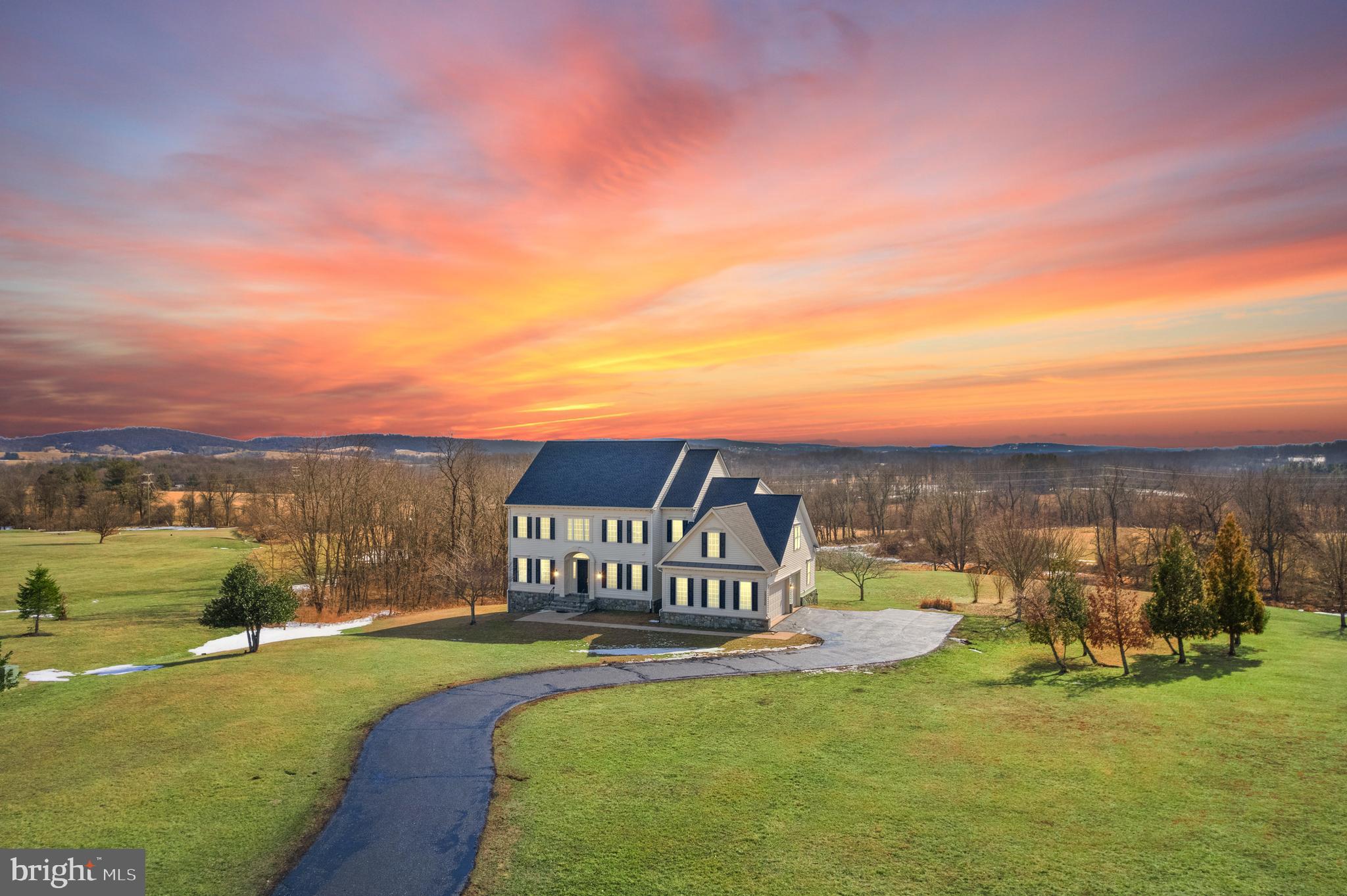 Enjoy an upscale quality of life in this luxurious estate home. Situated on 4.6 acres in a tranquil hamlet in this picturesque area of Lovettsville. This charming property seamlessly blends modern amenities with classic charm, offering a delightful living experience.  KEY FEATURES_NEW-NEW-NEW: Over $100,000 recently spent on updating and upgrades. New Roof, New paint, New Carpet, New (2) French Doors, New Exterior Trim, and More – 2024. Downstairs HVAC unit replaced – 2023. New water heater – 2023. Well Pump replaced – 2022. Upstairs AC unit(s) replaced – 2016. LUXURY BUILDING: This home also features grand10ft ceilings. Spacious open concept layout creates abundant natural light that is fresh and inviting. Walls of windows give way to gorgeous views. The atmosphere is perfect for hosting gatherings or just relaxing with family. MODERN KITCHEN:  The updated kitchen is the heart of the main level, truly any aspiring chef’s dream. The kitchen has stainless steel appliances and a gas range. The laundry room is on the main level and has an additional refrigerator to make storing extra groceries a breeze.  The adjoining family room is a restful retreat boasting a wall of windows showcasing pastoral views. The charming stone hearth creates a cozy escape on a chilly day. The main level is completed with a spacious office. UPPER LEVEL: two sets of stairways add convenience to access the inviting bedrooms. The master bedroom is a haven that is spacious and full of warm natural light and is very inviting. The walk-in closets are generous in size and the en-suite bathroom is beautifully adorned with a soaking tub to help ease away the stress of modern-day life.  The additional bedrooms and bonus room are sure to please. They are all equally spacious and welcoming. LOWER LEVEL: The versatile lower level adds additional living space that can be customized to your own needs. It boasts an additional bedroom, full bathroom, an inviting living space and its own full wet bar/kitchen area. A dream for any guests of family member to feel welcome in this lovely home. PRIVATE BACKYARD: Stepping outside, this home has two outdoor deck areas to enjoy the private and serene natural setting.   GREAT LOCATION: Situated in a quite neighborhood, this home is just minutes form the quaint historical town of Lovettsville. This adorable town has superb new restaurants and is near unique family-owned wineries. It’s easy to appreciate the downtown also has a co-op grocery store and a fitness center. BONUS-BONUS: This North facing home has a very large HEATED/COOLED garage with a stand alone Mini Split HVAC. For those of you who tinker in the garage, this is a little bit of heaven! the garage is also fitted with 20 Amp outlets and an auxiliary 50 amp feed for future needs.