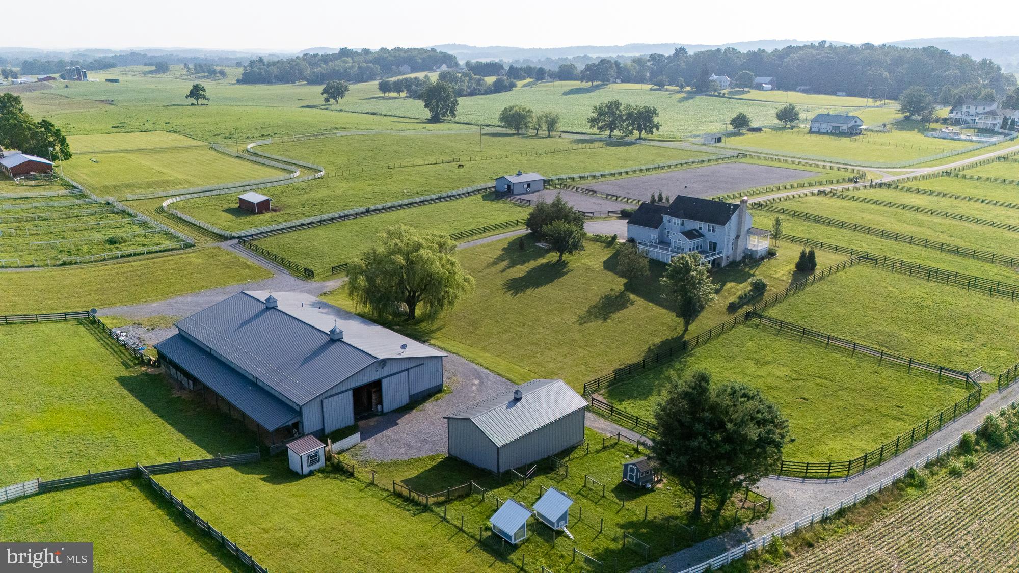 Offered in scenic Union Bridge, this 14.57-acre turnkey horse property is thoughtfully designed for ease, efficiency, and equine comfort. Set among working farms in Frederick County, this facility is ideal for private use or a boutique training and boarding operation.

The farm features three 3-stall (12x24') barns, each with individual run-outs and heated Nelson waterers, 16 paddocks with 4-board flex fence and electric, a Priefert round pen and 100' x 200' arena with bluestone footing. 

The main barn offers 20 matted stalls (13 small, 3 oversized 14x14', and 4 12x12'), heated Nelson waterers, and practical amenities throughout. A large matted wash stall with hot/cold water and swing arm, heated tack room, heated office/lounge, full bathroom, laundry room, 3-bay equipment shed, fully outfitted vet clinic and RV hook-up round out the features of this well-equipped property.

The 3-bedroom, 4-bath Colonial-style home with over 4,000 sq ft of living space includes a private basement apartment–perfect for guests or staff. The sizable living room with pellet stove and three walls of views greets you and opens to a large entertaining area that meets the kitchen. Cooks will be pleased with the Viking appliances and two pantries. The mudroom with wash sink and a half bath are conveniently located just inside the garage entrance for when you return from the barn. A huge laundry room on the bedroom level and expansive primary suite with dreamy walk-in closet and dressing area are an owner's oasis. The wraparound porch and deck provide scenic views of the paddocks and landscape, while the gated driveway with keypad entry adds security for residents and horses alike.

Book a tour today to experience all that this property has to offer!