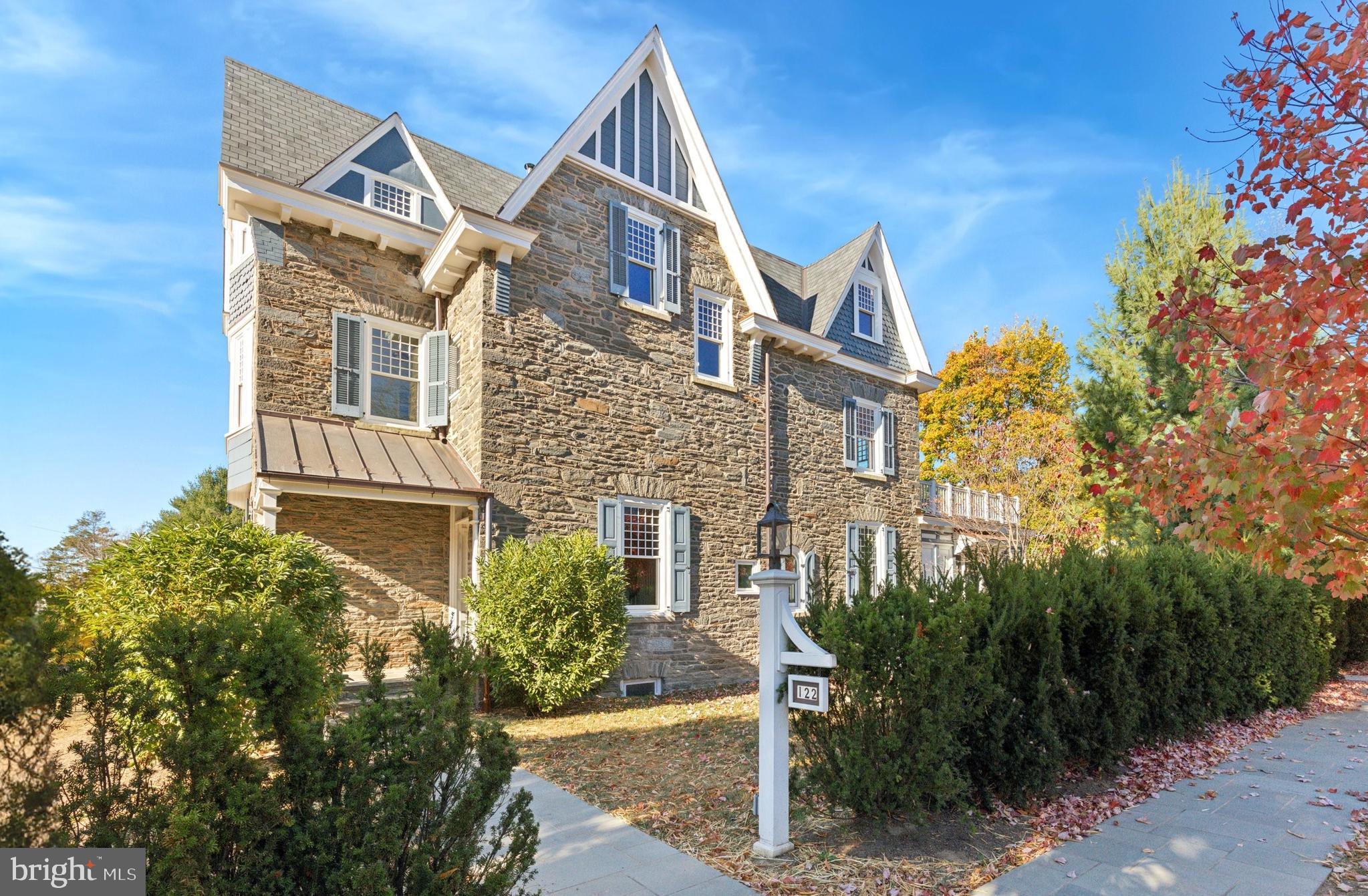 A rare find! Welcome to this sophisticated Queen Anne stone house meticulously updated and expanded by the current owner. Enter through the covered front porch to the interior vestibule leading into the large entry hall with a dramatic three-story open staircase. The first floor includes a cozy living room with built in bookcases and fireplace, large light-filled dining room with bay window and fireplace, powder room, butler’s pantry with wine refrigerator and recently renovated chef’s kitchen with stainless steel appliances, soapstone counters and custom cabinetry with a second set of stairs leading to the second floor. The eat in kitchen opens to a spectacular family room addition with exceptional millwork including built in entertainment center, desk and benches with an exposed ribbon jointed Wissahickon shist stone wall. In 2021, the owner was awarded a Preservation Recognition Award by the Chestnut Hill Conservancy for the care they took in building this addition. The second floor includes a primary bedroom with built ins and en suite bath, second bedroom with fireplace and an office that leads to a large balcony with wood decking built over the family room addition. A second full hall bath and multiple hall closets complete the second floor. The third floor includes three additional bedrooms and a full hall bath. Refinished hardwood floors, custom replacement windows throughout with deep window sills and high ceilings. Updated systems include central air conditioning, electrical (wiring and buried power and data cables to house and garage - 400 Amp to house and 200 Amp to garage for EVs), roof with new eaves and copper gutters, septic system, water main and a refurbished cistern to collect roof water that can be connected to supply an irrigation system to the property. Detached two car stone garage with Belgian block driveway accessing the cross street of Newton Street. Pennsylvania bluestone patio and walkways and a large flat yard to enjoy year round. Short walk to the heart of Chestnut Hill shopping, restaurants and transportation. This is a extraordinary property that exemplifies what makes Chestnut Hill a special place to call home.