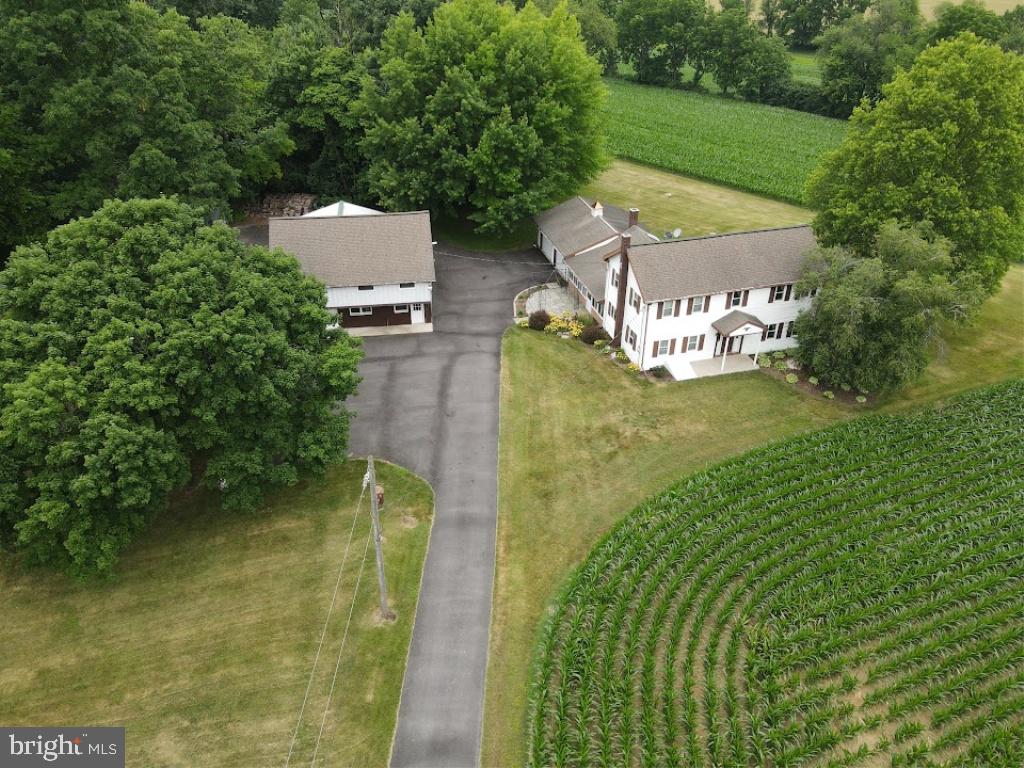 This property will be offered at Public Auction on Saturday, August 29, 2026 @ 12pm.  The listing price is the opening bid only and in no way reflects the final sale price.  10% down due at auction, 2% transfer tax to be paid by the purchaser, real estate taxes prorated. This perfectly secluded yet conveniently located 2-acre Rapho Township property is accessed by a long private lane, offering picturesque country views as you approach the home. The property is bordered by cornfields and mature woods, creating a peaceful rural setting. The picturesque buildings include a traditional two-story, three-bedroom farmhouse featuring a large family room, sun porch addition, and an attached oversized two-car garage. Other buildings and improvements include an improved 34' x 28' two-story barn with second-floor office space that formerly supported a small contracting business. Additional amenities include a 24' x 24' two-bay pole shed, a 44' x 20' masonry shop with two overhead garage doors, and a 20' x 20' detached metal carport. Conveniently located less than 10 minutes from Manheim, Mount Joy, and Route 283, this is a once-in-a-generation opportunity to purchase a private country homestead with ample space for equipment, hobbies, storage, or a home-based business, all in a beautiful setting that's perfect for raising a family. While the property could benefit from cosmetic updates, it has been well cared for throughout the years.