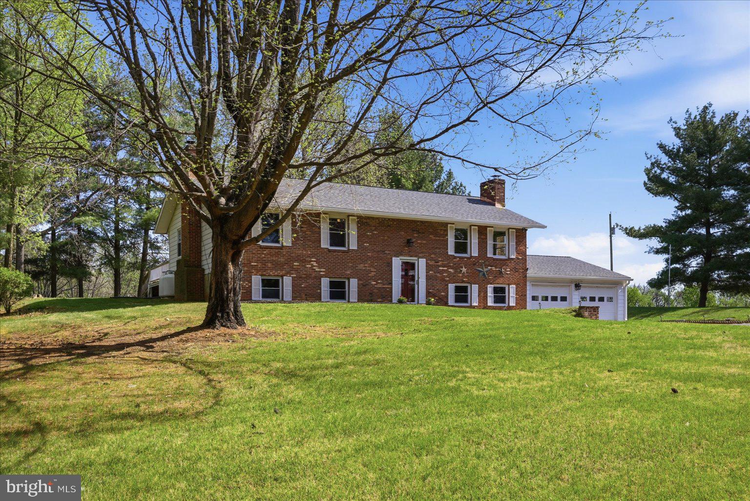 Welcome to 2755 Allen Road in Berryville—a Beautiful and Private property offering space, versatility, and a peaceful rural setting in desirable Clarke County with no HOA!   Bordered by aromatic pines and surrounded by views of the countryside this home offers function and tranquility. 

This 3-bedroom, 2.5-bath home features a functional layout with comfortable living spaces and a walk-out basement that provides a spacious family room—ideal for relaxing, entertaining, or flexible use. The home is serviced by well and septic, with electric baseboard heat, window A/C units, and a propane heating stove in the basement for supplemental warmth.

Recent improvements include a brand new roof and guttering (April 2026) and a new electric hot water heater. A whole-house generator adds convenience and peace of mind.

Outdoor features are a standout, with an attached 2-car garage plus an impressive detached 4-car garage that includes a large bay suitable for a camper or oversized vehicle. Multiple additional storage buildings and sheds offer ample space for equipment, hobbies, or workshop needs. The setting provides privacy with open space between neighboring homes and opportunities to enjoy local wildlife from the property.

Conveniently located near Routes 7 and 340, this home offers access to commuter routes while maintaining a quiet, rural atmosphere. Nearby, the Town of Berryville offers a charm on Main Street with shops, dining, and community events, along with parks, recreation facilities, and the annual Clarke County Fair.
