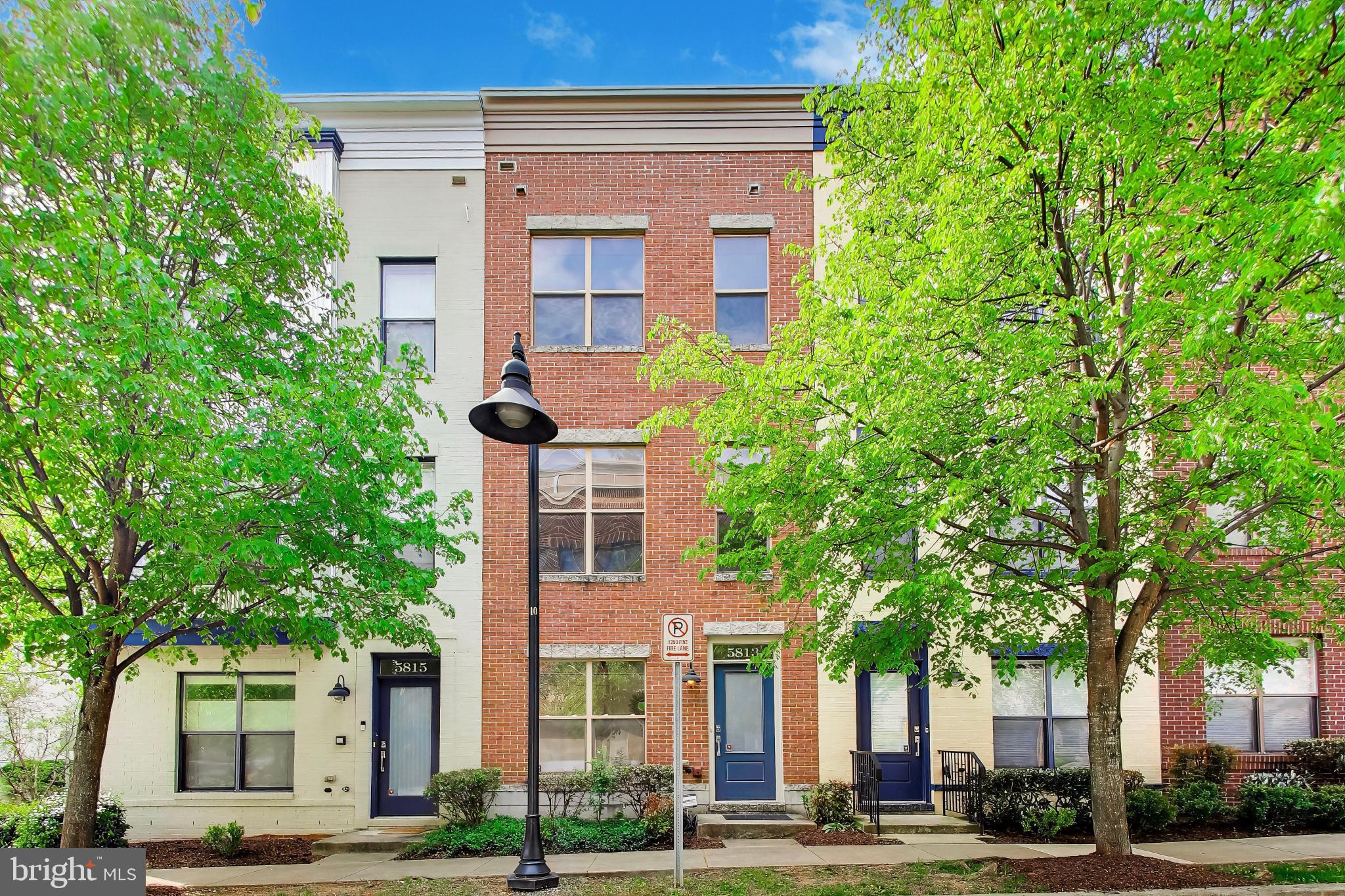 Discover an exceptional opportunity to own a beautifully maintained, turn-key townhome in the heart of the vibrant Arts District at 5813 Lustine Street, Hyattsville, MD 20781. This spacious residence features 4 bedrooms—a rare and highly desirable offering in the community—along with 3.5 well-appointed bathrooms, blending comfort, style, and everyday convenience.

Spanning four thoughtfully designed levels and filled with natural light, the entry level features a full bedroom that can also be used as a home office, along with direct garage access.

The main living level (second floor) is bright and open, featuring gorgeous hardwood floors throughout the living room, dining area, and kitchen, along with hardwood stairs and hallways. The space flows seamlessly into a stylish kitchen with granite countertops, stainless steel appliances, sleek wood cabinetry, and a breakfast bar peninsula, plus a convenient powder room.

Upstairs, the third level offers a spacious primary suite with a walk-in closet featuring custom built-in shelving and a luxurious ensuite bath, along with a third bedroom with its own private ensuite full bathroom.

The fourth level provides a versatile flex space ideal for entertaining or relaxing, along with a fourth bedroom featuring its own ensuite full bath. Multiple ensuite bathrooms throughout the home create a level of comfort and privacy rarely found in townhome living.

Residents enjoy access to outstanding community amenities including the Lustine Center gym, pool, business center, lounge, tot lots, and a community shuttle to the Metro. Ideally located within walking distance to YES! Organic Market, Whole Foods, Busboys & Poets, Franklins, Vigilante Coffee, Streetcar 82, local breweries, parks, and scenic jogging and biking trails, with excellent commuter access via the Riverdale MARC station just half a mile away and downtown DC approximately 6 miles away.

A rare 4-bedroom, multiple-ensuite opportunity in one of Hyattsville’s most desirable communities—beautifully maintained and completely turn-key.