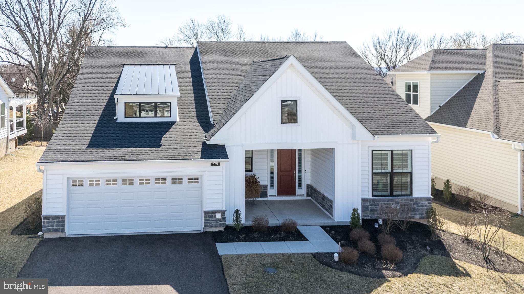 Have you been searching for one floor living and a carefree lifestyle?  Then look no more!   This beauty, built in 2022, is available immediately.   You will absolutely fall in love with this beautifully upgraded single home which makes downsizing easy!   Located in the sought after Regency at Kimberton Glen by Toll Brothers, an active adult community.   Welcome to 679 Stamp Street with its covered front porch, luxurious plank floors throughout,  an abundance of windows all covered with plantation shutters and recessed lighting are just some of the amenities found is this wonderful home.  This well maintained home provides a sophisticated design with sunlit spaces offering an open floor plan with volume ceilings.  The sprawling, upgraded gourmet kitchen is a chef's dream with tremendous cabinet and quartz counter space offering easy close drawers,  large center island with storage and seating for six,  stainless steel appliances,  pantry,  tile back splash,  gas cook top with hood, wall oven, under counter and recessed lighting.  A sliding door with transom affords access to a covered porch and newly built custom deck for seamless indoor-outdoor gatherings. The great room is the heart of the home with its gas fireplace, a door to another covered patio and convenience to the kitchen.  Company coming?  Entertain in uncrowded comfort in the dining room located adjacent to the great room where you can expand your table for entertaining.   Enter through double doors to a wonderful library/office, perfect for quiet study times and providing a ceiling fan.  Retreat to the master suite boasting a tray ceiling for added height, ceiling fan and walk-in closet with organizers.  The sumptuous master bath provides dual vanities offering Kohler glass bowls and a frameless tile oversized shower with two built-in seats.  A guest bedroom featuring a ceiling fan and a ceramic tiled  bath are tucked away offering privacy.  A nicely sized laundry room with front loading washer and dryer, utility sink and built-in cabinetry leads into the 2 car garage.  The garage provides an epoxy floor, workshop table in the alcove and an entry door leading upstairs to the floored, stand up attic on the second level.  You'll enjoy spectacular on-site amenities including a community clubhouse, outdoor swimming pool, patio and lounge areas, pickle ball/ tennis, fitness and exercise room,  billiard area,  walking path and more! Stress-free low-maintenance living with lawn care, landscaping, and snow removal right to your door provided.  Just a short walk away from downtown Phoenixville where you can enjoy a variety of restaurants, shops and events.