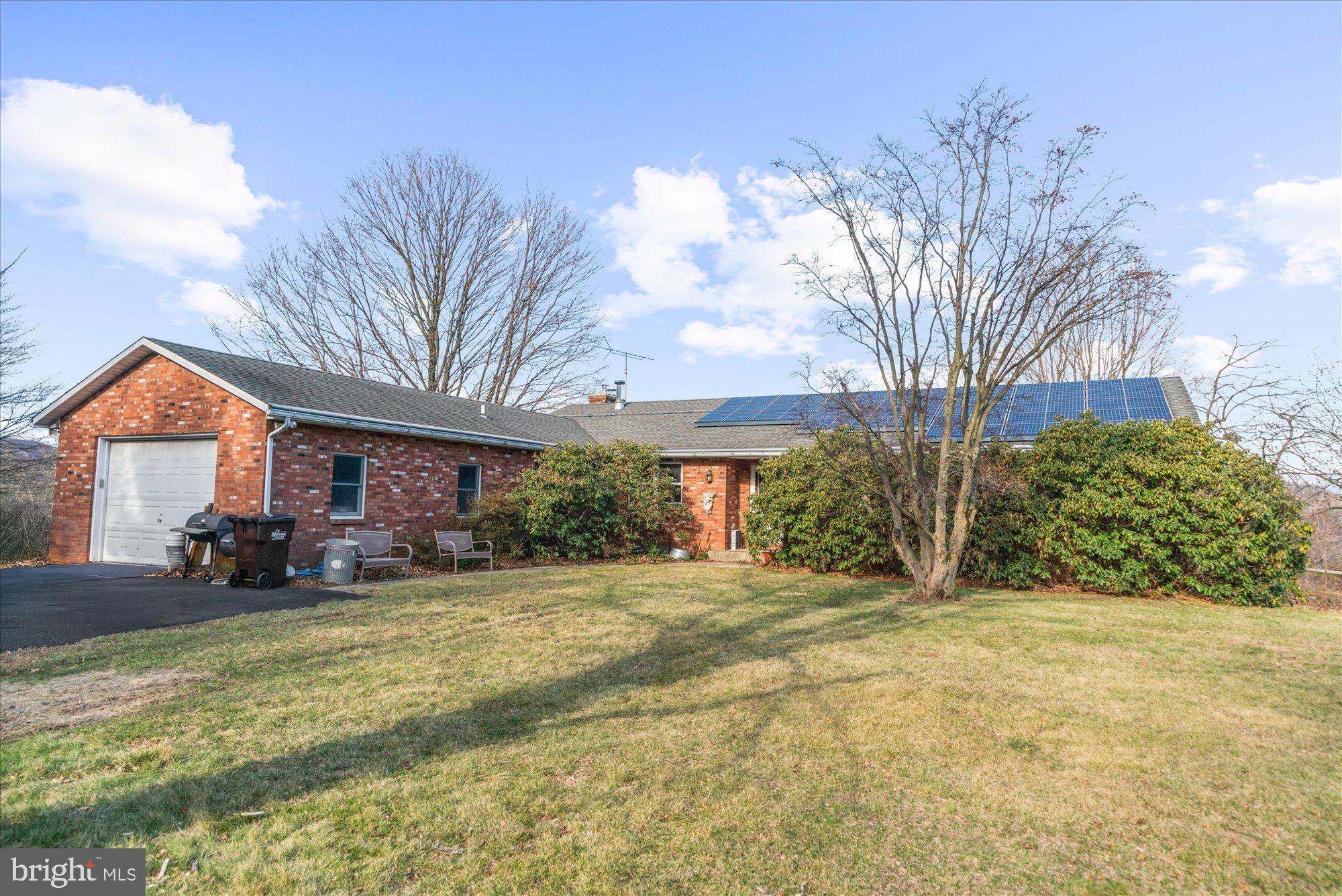 A tree-lined drive leads to breathtaking views  with this three bedroom, 2.5 bath ranch home on more than seven acres of what once was an orchard, fruit trees and native plantings still gracing grounds.  A timeless solid brick ranch home, with living room, family room, two brick fireplaces, and a full basement with a finished area that gives another 1000+ sq ft of living space along with a workshop that provides access to grade.  Enough can not be said about the lot, with panoramic views and what was once a beautiful in-ground pool with spa along with a detached garage and shed for additional storage.  The home and grounds need life breathed back into them, and when they do, this property will be worth as much as the views...