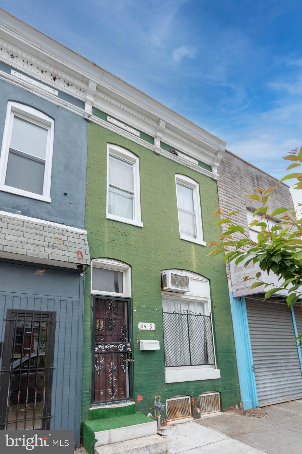 List price is opening bid. Online Auction Only! Bidding begins Saturday, June 4th, and ends Tuesday, June 9, 2026 at 11:00AM. 

2419 E. Monument Street is a classic brick-front townhouse located in the vibrant McElderry Park neighborhood of East Baltimore. Currently configured as a residential property, the home is zoned C-1 Neighborhood Business District, offering excellent flexibility for future residential, commercial, or mixed-use possibilities. The property is vacant and presents a great opportunity for an owner-occupant or investor seeking a potential rental property.

Conveniently situated near Johns Hopkins Hospital, downtown Baltimore, Patterson Park, and the amazing Port Street Garden (The space includes community gardens, gardening education and activities, youth art, and numerous other activities) this location provides easy access to neighborhood amenities, green space, dining, and major commuter routes. With strong redevelopment activity throughout the surrounding area, this property offers both immediate potential and long-term upside.

Main Level contains a living area, dining area, kitchen, and access to the rear yard.

Upper Level is complete with 2 bedrooms, a bonus room, and a full bathroom.

The lower level consists of a full unfinished basement with laundry hookups, a gas water heater, and electric meter access.

Exterior Features include a fenced rear patio area suitable for outdoor use or entertaining.

The property is located within the C-1 Neighborhood Business District, which is intended to support pedestrian-oriented commercial corridors and neighborhood-serving businesses. According to the Baltimore City Zoning Code, the district is designed to ensure compatibility between residential and commercial uses, maintain appropriate commercial scale, and address the unique characteristics of smaller commercial sites.

Situated in East Baltimore’s McElderry Park neighborhood, the property benefits from close proximity to major employers, public transportation, neighborhood amenities, and ongoing community redevelopment initiatives.

Note: 2421 E. Monument St. is also being offered for auction on the same date at 11:30am.