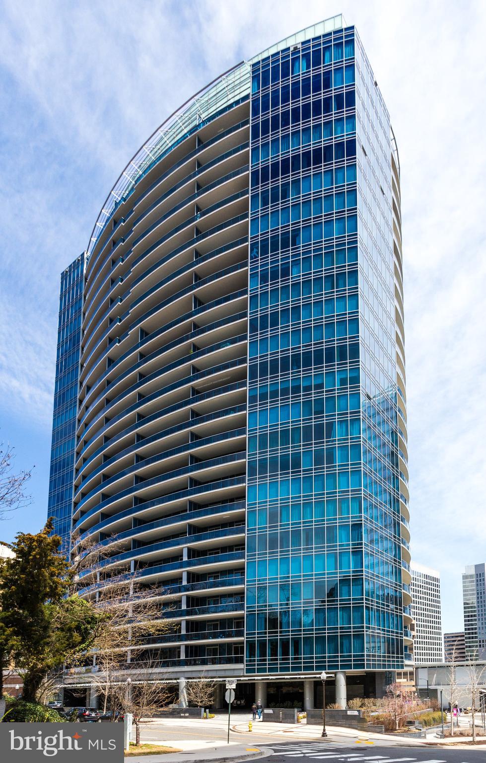Welcome to luxury living at its finest in this exquisite contemporary high-rise condo located at 1881 N Nash St, Arlington, VA. Spanning 1,312 square feet, this one-bedroom, one-and-a-half-bathroom residence offers a sophisticated urban lifestyle with unparalleled amenities.

Step inside to discover a sun-drenched oasis, thanks to floor-to-ceiling windows that bathe the interior in natural light. The open concept design is accentuated by elegant marble floors and recessed lighting throughout. Culinary enthusiasts will be inspired by the chef's kitchen, complete with premium counters, an island, stainless steel appliances, a wall oven, and a dishwasher.

Retreat to the primary ensuite, which features a marble bathroom with a double sink, separate shower, soaking tub, and a serene atmosphere for ultimate relaxation. Step out onto your private balcony to take in wonderful local views.

This luxury building offers an array of amenities to enhance your lifestyle, including an indoor pool, spa, gym, health club, yoga studio, and screening room. Enjoy the convenience of valet parking and the peace of mind provided by on-site security staff. Additional perks include concierge services, and private storage available for rent.

Whether you’re hosting in the common media/recreation room or enjoying the tranquility of your private space, this condo offers the perfect blend of comfort and convenience. Experience an elevated lifestyle in this exceptional high-rise community.