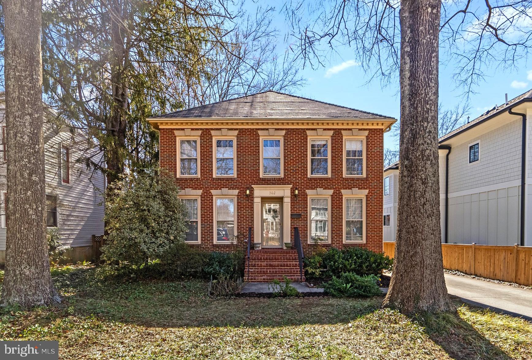Welcome to 302 North Oak Street, a charming brick Williamsburg colonial in the heart of Falls Church City! This lovely 5 bedroom, 3.5 bath home has been meticulously maintained and updated by its owners over the years offering classic charm all within walking distance to top-rated schools, a variety of shops, and many popular restaurants. Inside, you will find a gracious entry foyer flanked by an elegant living room and spacious dining room for formal entertaining. The updated kitchen features white 42” cabinets, granite countertops and a dining area, with open access to the inviting family room and cozy wood-burning fireplace. French doors lead to a generous two-level deck with room to host a crowd. There’s a detached 2-car garage, a large play house or storage shed, and ample driveway space for a basketball hoop or extra parking. Upstairs, the primary suite boasts a walk-in closet and en-suite bath with Jacuzzi tub, while three additional bedrooms share a well-appointed hall bath. The fully finished lower level provides flexibility with another bedroom and full bath, a spacious recreation room, laundry room, and two storage areas. From here, you can easily walk to the Falls Church Public Library, the popular weekly farmers market, multiple parks, the W&OD Trail, coffee shops and grocery stores. Commuting is effortless with quick access to two Metro stations, bike-friendly routes into D.C., and major roadways including I-495, I-66, Route 7, and Route 29, welcome home