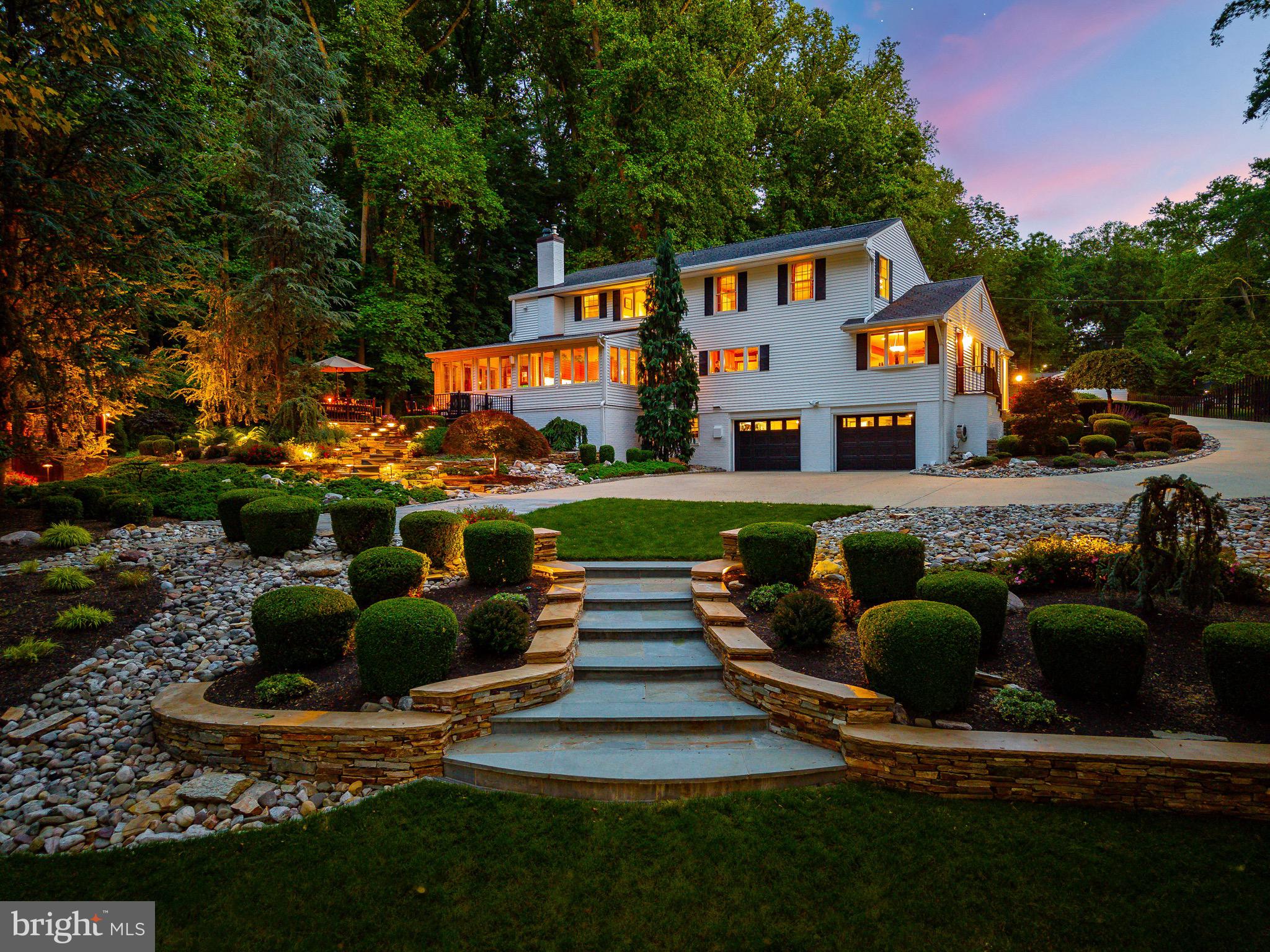 Set against the backdrop of the historic Delaware Canal this exceptional residence offers a level of privacy and serenity that is increasingly difficult to find. Beyond the home itself lies a landscape that has been thoughtfully designed to inspire and impress—magnificent terraced gardens, winding stone pathways, specimen plantings, dramatic retaining walls, and extensive low-voltage landscape lighting transform the property into a private resort-like sanctuary.

From the moment you arrive, the artistry of the stonework commands attention. Bluestone walkways and handcrafted stone terraces gracefully guide you through lush gardens and manicured grounds, creating an unforgettable first impression. As evening falls, the illuminated landscape takes on a magical quality, casting a warm glow across the property and highlighting the beauty of every garden bed, pathway, and mature tree.

At the heart of the outdoor experience is an expansive entertaining terrace overlooking the gardens and canal beyond. Whether hosting elegant dinner parties, enjoying morning coffee, or gathering with friends beneath the stars, the setting is nothing short of spectacular. The adjoining gazebo, crafted from red cedar and mahogany, provides a four-season retreat where one can relax while surrounded by nature in every direction.

Inside, the residence offers beautifully appointed living spaces enhanced by custom millwork, handcrafted cabinetry, rich hardwood flooring, and thoughtfully curated finishes throughout. A remarkable library showcases exquisite built-in woodwork and provides a sophisticated retreat for reading or conversation. A private office suite with its own entrance offers exceptional flexibility for today's work-from-home lifestyle, while an additional study creates yet another inviting space to work, create, or unwind.

The gourmet kitchen is designed for both everyday living and entertaining, featuring Wolf and Sub-Zero appliances, radiant heated flooring, custom cabinetry, and seamless access to the outdoor living spaces. The home's advanced mechanical systems include six-zone HVAC with steam humidifiers, dehumidifiers, air scrubbers, whole-house generator, security system with video monitoring, and temperature-controlled attic insulation, delivering comfort and peace of mind year-round.

The primary suite serves as a private sanctuary highlighted by a spa-inspired bath featuring an oversized marble shower with tranquil views toward the Delaware Canal and seasonal Delaware River vistas. A Scandinavian sauna further elevates the home's wellness experience.

With Delaware Canal frontage along the rear of the property, seasonal river views, preserved woodland surroundings, and gardens that rival those of a private estate, 15 Stafford Place offers an extraordinary opportunity to own a home where nature, luxury, and lifestyle exist in perfect harmony.