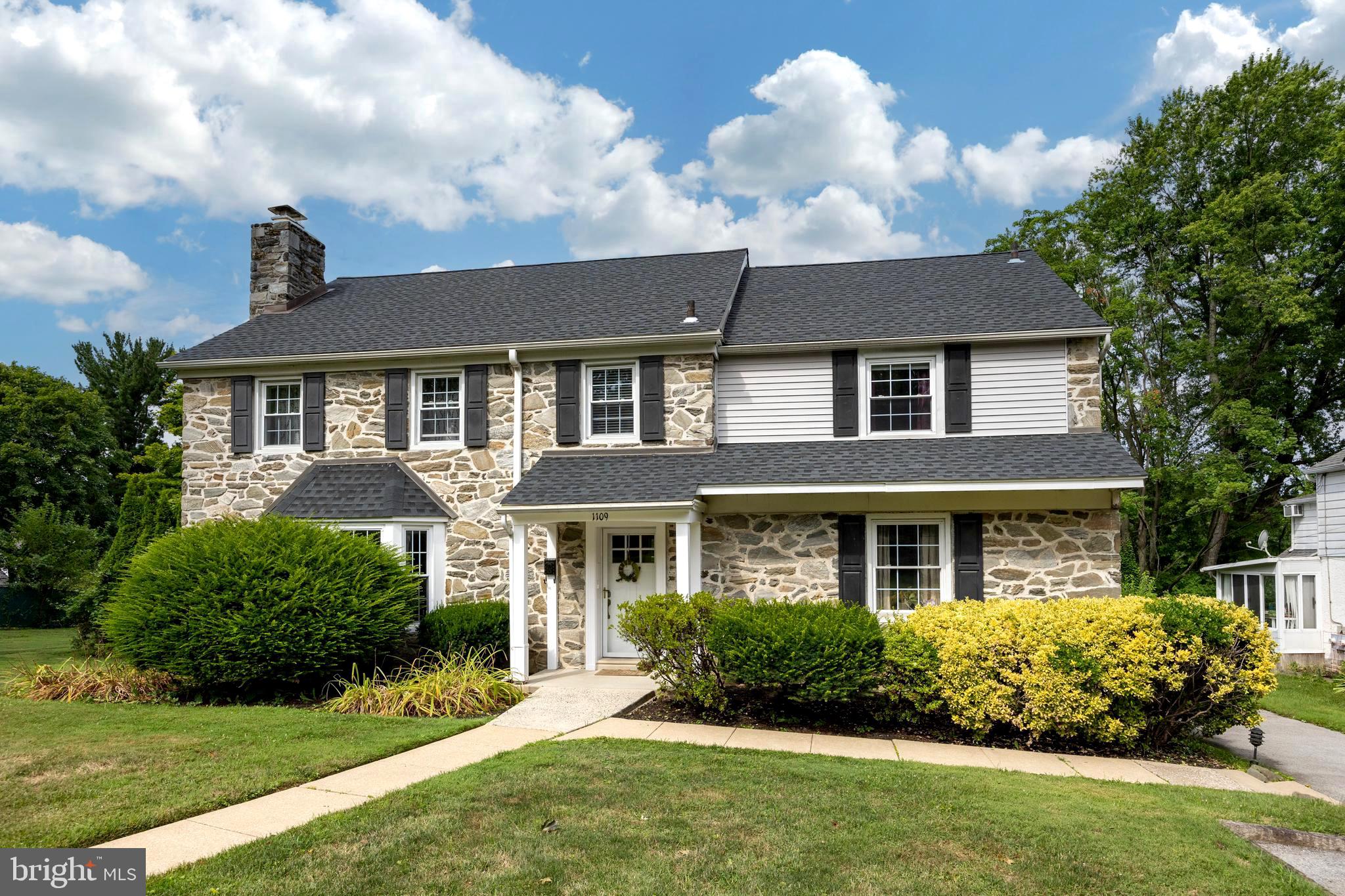Welcome to 1109 Ashton Road, Wynnewood, PA! Nestled in the desirable Wynnewood Valley neighborhood, this charming five-bedroom Mainline Stone Colonial offers timeless elegance and modern amenities.

Step inside to discover gleaming hardwood floors and recessed lighting throughout. The spacious living room, featuring a cozy wood-burning fireplace, is bathed in natural light, perfect for relaxing or entertaining. The first floor includes a convenient home office, ideal for remote work.

The kitchen has been updated with a contemporary stainless steel appliance package, breakfast bar, and sleek cabinets and countertops. Adjacent to the kitchen is an additional living area with a vaulted ceiling and skylights. Connected to the dining area and living room, a side porch offers an ideal space for entertaining guests.

Upstairs, you'll find an updated primary bedroom with an en suite bathroom. Also on this level are three additional bedrooms and a full bath. The third floor offers a versatile fifth bedroom or extra living space finished to suit your needs.

The home features a finished lower-level basement with a powder room, laundry area, plenty of storage, and additional living space. An entertainment bar adds a stylish touch for hosting gatherings.

The attached two-car garage provides ample parking and storage. Outside, enjoy a beautiful, level lot with a fenced-in, tree-lined in-ground pool, offering plenty of privacy and perfect for summer fun.

This property is part of the award-winning Lower Merion School District and is convenient to local restaurants, Suburban Square, schools, and is just a five-minute walk to the train station and plenty of shopping, including Whole Foods.

Don't miss out on this exquisite home in a prime location!