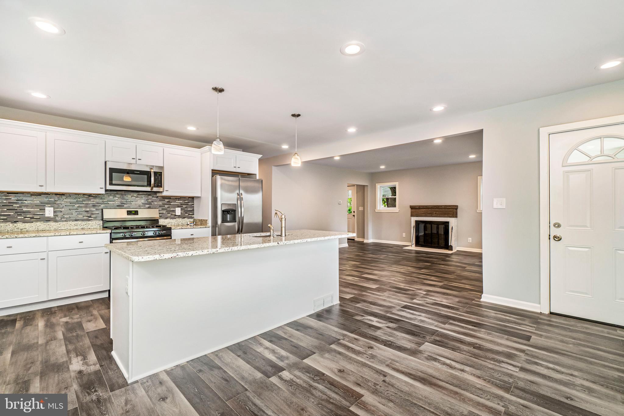 Superb total renovation of an all brick single family home on a quiet street with private 3 car parking. Home features gorgeous floors, an open concept first floor with an upgraded wood burning fireplace, stainless steel appliances with gas range, granite counter tops, private 2nd floor master retreat with on-suite and 2 large walk-in closets, 3 additional first floor bedrooms with beautiful bathroom, central HVAC, gas HWH, finished basement with walkout and half bath, new roof and meticulously landscaped yard.