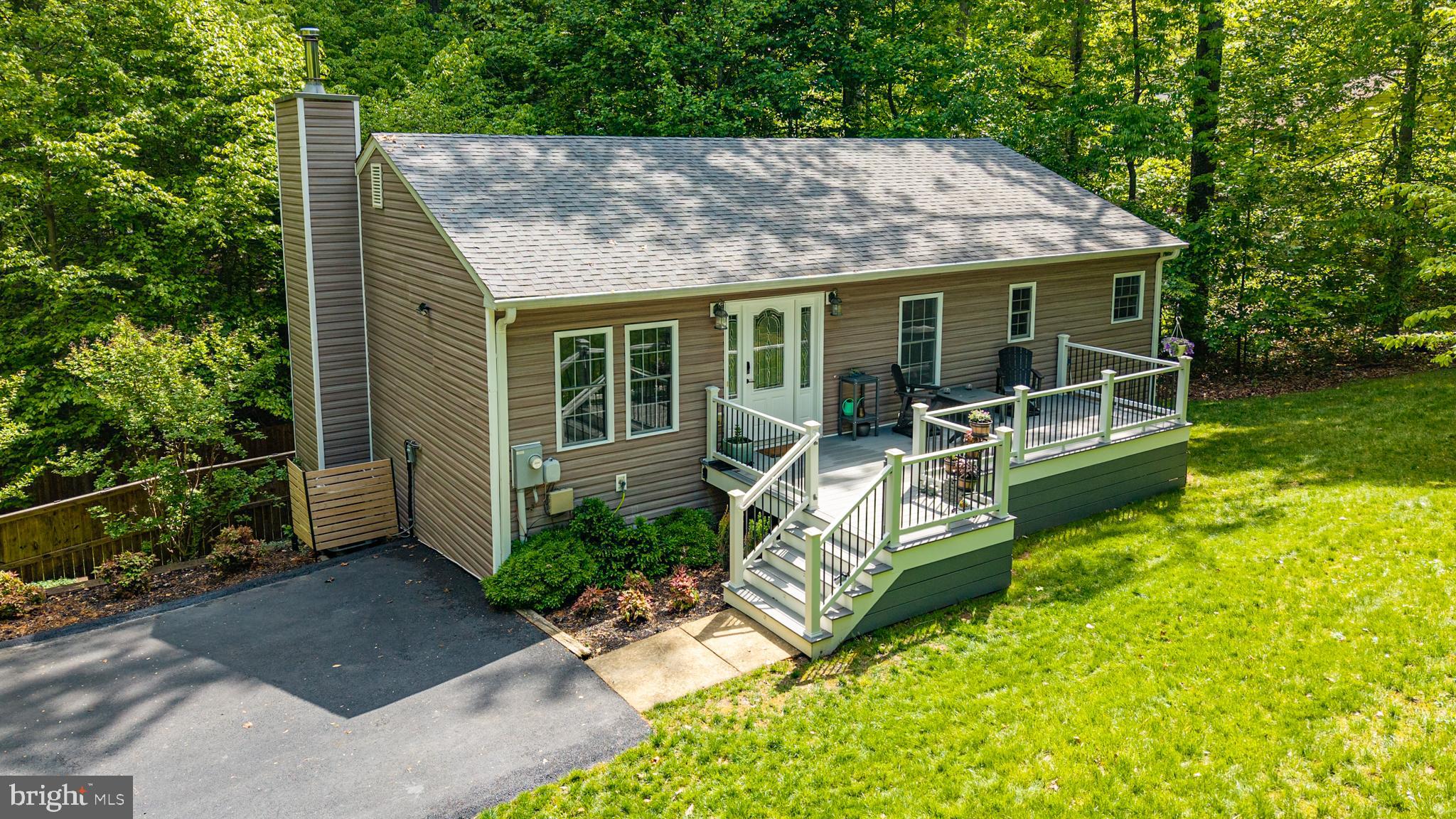 Nestled in the private neighborhood of Lake Jackson, this move-in ready, 3 bedroom, 2.5 bath, raised-ranch home offers a 1.03-acre wooded retreat while still being conveniently located to many local amenities! THERE IS NO HOA.  As soon as you arrive, you will be treated to a number of high-end outdoor upgrades to include a beautiful new front porch, a private patio inside a fully fenced backyard, a paved driveway, an upgraded retaining wall and newer shed installed on a concrete pad. From the new front porch to the private back patio and everything in-between, you will love this move in ready home! Freshly painted throughout with all new carpet; all you need to do is bring your furniture. This great home offers three spacious bedrooms, 2 full baths, a half bath, a sitting room, family room, separate dining room, 2 bonus rooms and a perfectly sized kitchen. Both the HVAC and hot water tank were replaced in 2023 and most of the appliances have been replace within the last 5 years. The surrounding area is a nature lover's paradise, with the picturesque Lake Jackson just moments away. Enjoy the recreational activities that the lake provides, such as fishing, relaxing on a pontoon boat, water skiing, jet skiing, canoeing, kayaking and more. There are multiple major commuting routes and it is only 15 minutes away from Old Town Manassas and the VRE. So close to numerous restaurants, shopping, multiple farmers markets, activities and so much more! The neighborhood is known for its friendly atmosphere; come experience the best of Lake Jackson living, where tranquility meets community.