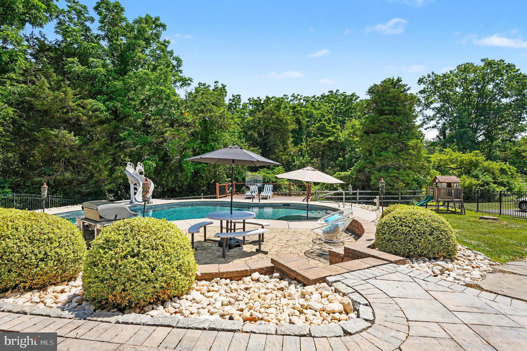 A Private Estate Designed for Exceptional Living tucked away on 2.53 private acres at the end of an exclusive cul-de-sac of only six homes. This extraordinary estate offers a rare combination of luxury, privacy, and resort-style living. Backing directly to the natural beauty of Evansburg State Park, you’ll enjoy peaceful wooded views and a setting that feels like a private retreat while remaining just minutes from everyday conveniences.  Designed with entertaining in mind, the main residence showcases beautiful hardwood flooring throughout, a thoughtfully updated kitchen featuring elegant quartzite countertops and a striking tile backsplash, remote-operated sun shades in the family room, and the majority of light fixtures have been tastefully updated.  Just off the main living area, a spacious Trex Deck with a Sunseta Retractable Awning, and stairs that leads to your backyard oasis.  Step outside and discover your own private resort. The saltwater pool is complemented by an inviting covered patio and a beautifully appointed pool house/changing area complete with a bar, mini-split air conditioning, and cable wiring – creating the perfect setting for unforgettable summer gatherings.  One of this property’s most exceptional features is the detached two-car garage topped by a fully equipped Carriage House, offering a private one-bedroom suite complete with a full kitchen, living room, and full bath. This bed and bath are added to the total bedroom and bathroom count. Whether accommodating extended family, an au-pair, long-term guests, or creating a private home office, the possibilities are endless.  The spectacular walkout lower level expands the home’s entertaining capabilities even further, featuring a stunning new custom-built wet bar with quartz countertops and Dekton material on the sides and front, along with color changing accent lighting, a spacious recreation area, an additional bedroom, full bath, abundant storage, and direct access to the covered patio. This level was designed for hosting family and friends year round.  Flexibility continues throughout the main level with a front flex room that easily serves as a home office, library, an additional bedroom, or playroom.  On this level there is also an updated powder room for convenience.  Car enthusiasts, hobbyists, or those needing exceptional storage will appreciate the impressive five-car garage capacity, including an attached three-car garage and the detached two-car garage.  Recent improvements provide tremendous peace of mind, including a brand-new 2024 roof with premium shingles and a transferable warranty, new 400-amp electrical service, replacement of the well bladder, a comprehensive alarm system protecting the entire property, and attractive dusk-to-dawn exterior lighting.  Despite the peaceful setting, this remarkable home is conveniently located just minutes from the charming village of Skippack, where you’ll enjoy boutique shopping, award-winning restaurants, seasonal events, and easy access to major commuting routes, including the PA Turnpike.  Combined with very low HOA fees this is a rare opportunity to own an exceptional estate that truly offers the best of luxury, comfort, privacy, and convenience.  Take a Look, Fall in Love, Make an Offer.