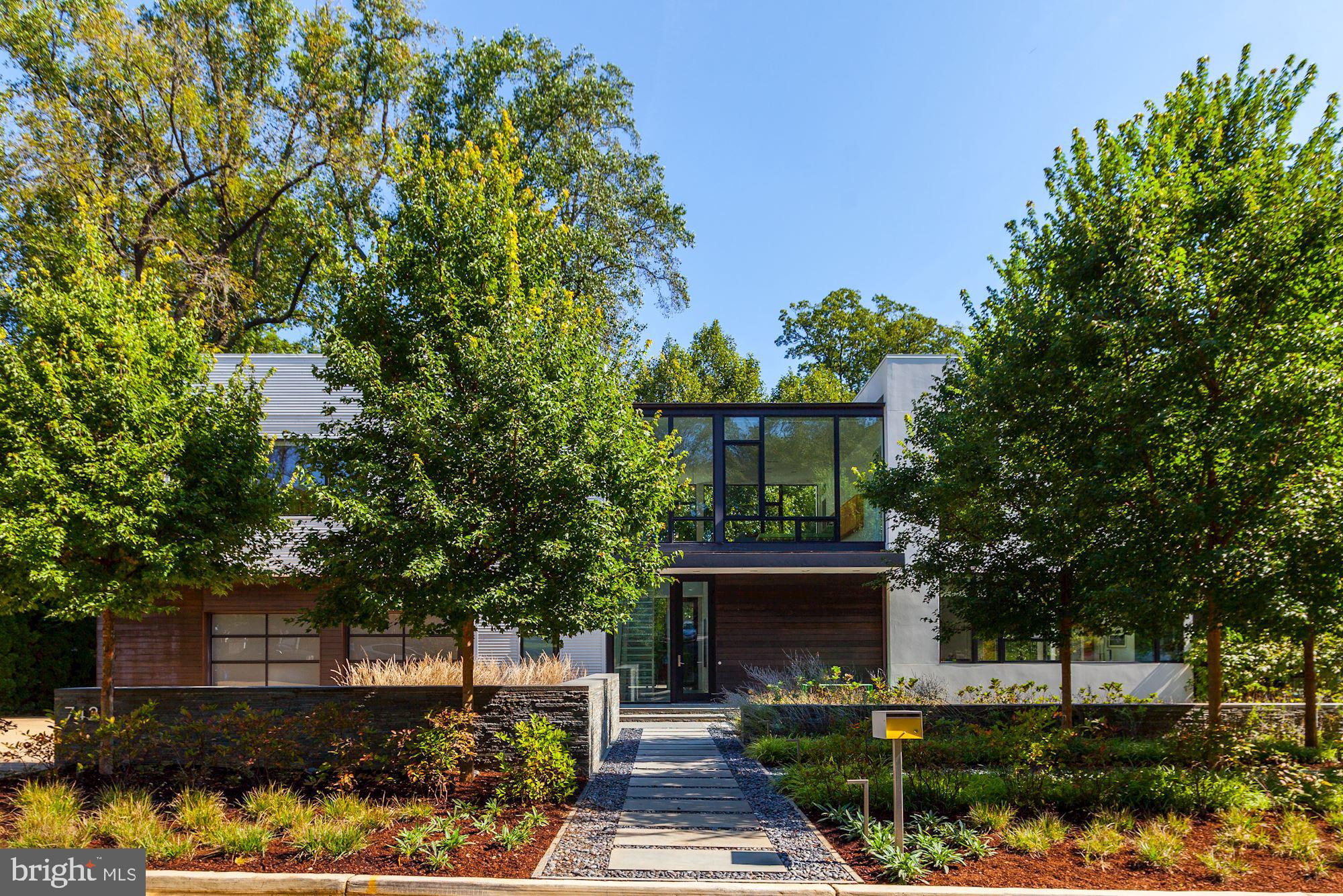 Easy showing times.  Welcome home to your ideal retreat from the city in close in Edgemoor.   Enjoy the splendor of lush, elegant landscaping along with a custom pool and outdoor entertaining areas that double your living space. This oasis is simply spectacular.  Designed by renowned architect Robert M. Gurney this stunning contemporary is an exquisite masterpiece.  The residence was chosen to be sited by its thoughtful owner on sought after Hampden Lane in this desirable Bethesda neighborhood.    The beautiful custom finishes include floor-to-ceiling insulated glass windows, maple flooring,  floating stairs, walnut millwork and Spanish cedar throughout.  The custom floor plan flows seamlessly from the welcoming two story foyer into the dining room, living room, open gourmet kitchen and breakfast room.  Listen to the waterfall while enjoying your breakfast or casual dinner.   All of these rooms open to a wrap-around deck, swimming pool, spa and custom landscaped garden. A few steps toward the back of the main hallway you will find an inviting family room.   The year round  screen porch with fireplace welcomes the outdoors in.  The main level also  includes a powder room and  huge custom walk-in closet/mudroom and second laundry.   Gliding pocket doors open to the hallway leading  to an oversized 2 car garage.  In the main foyer the floating glass and aluminum staircase guides you effortlessly to the upper level where a welcoming second living room/family room overlooks the front and back gardens. The master suite is composed of the master bedroom, the master sitting room/alternate 5th bedroom or walk in dressing room and master bath which all echo the fine finishes found throughout the entire home. The second wing of the second story provides another 3 spacious bedrooms, 2 full baths, more than ample custom closets and a large spacious laundry room. The lower level of the home continues in its architectural splendor to guide you to the full service exercise room in opaque glass. The lower level recreation/game room includes a powder room, huge storage closet and guest bedroom with full bath.  Additional features include high ceilings throughout all three levels, custom lighting, sound and generator.  Professionally designed landscaping and stone work complete the fine finishes of The Gurney Glass House. A total of 5 bedrooms and 4 full baths with 2 powder rooms.  A once in a lifetime opportunity to own a masterpiece.  Minutes to downtown Bethesda on the C and O trail. Equidistant between Reagan National and Dulles Airports.  Twenty minutes to downtown DC.   Welcome home to your new sanctuary!