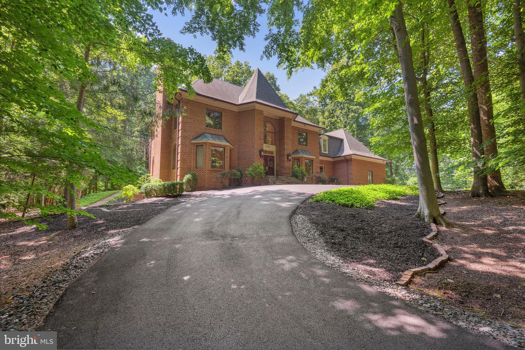*** This stunningly renovated home offers a distinctive lifestyle with its distinctive features and attention to details. Elegantly sited on 2.4+ acres with 4 finished levels, this home has been completely renovated with exceptional design and craftsmanship. In 2014, BOWA renovated the owner's suite to add new features such as a steam shower, walk-in closets for both him and her, separate water closets, a laundry room, a sitting room, heated floors, travertine tiles and expanded living space with hardwood floors. In 2018, the kitchen underwent renovations that included the addition of Wolf and Subzero appliances, an ice maker, wine coolers, and new, stylish Omega cabinetry. Additionally, the entire house is equipped with a 45 KVa Kohler generator. In 2019, the basement was remodeled and now features heated tiled floors, two fully updated bathrooms, and two extra rooms that can be used as an office or exercise space. This home features four fireplaces, two of which have been converted to gas for a cozy and inviting atmosphere while entertaining. The main level boasts an elegant living room and a formal dining area - perfect for hosting extravagant dinner parties. The kitchen which overlooks the backyard has generous counter and storage spaces. The adjoining family room is the perfect place to unwind and relax with family and friends.  It features a high ceiling, a cozy fireplace and large windows that allow natural light to come in with a new exquisite wet bar. Three additional spacious bedrooms and two full baths offer comfortable living for family and guests. The 4th level offers a walk-in closet and a full bath that’s perfect for kids’ playroom, sleepovers or quiet reading time. The walk-out lower level is an entertainer's delight, with a large recreation room with cove lighting, wood burning fireplace and wet bar. The main level offers a mudroom with a laundry facility, wine fridge, full size refrigerator and dishwasher. The sweeping backyard is an oasis of tranquility, with lush landscaping, and two patio areas perfect for al fresco dining. The newly Trex deck off the family and kitchen was installed in 2019 and is a perfect way to unwind while enjoying nature. This home is further enhanced with a newly repaved circular driveway and a three-car garage. The main entrance steps and driveway have a heated snow melt system and there are security cameras throughout the exterior of the home. This home also offers a 3-zone newer HVAC system. The utility room and garage spaces have been updated with lots of storage shelving. With easy access to major commuter routes, shopping, dining, and entertainment options, this is the perfect place to call home. For anyone seeking a luxurious abode in Great Falls, this property is an opportunity not to be missed. It's clear that meticulous planning and design have gone into creating this incredible residence, making it a true gem in the real estate market. 5 minute drive to River Bend Golf & Country Club, a short walk to Potomac River and L'Auberge Chez Francois! Click on 3D Virtual Tour.