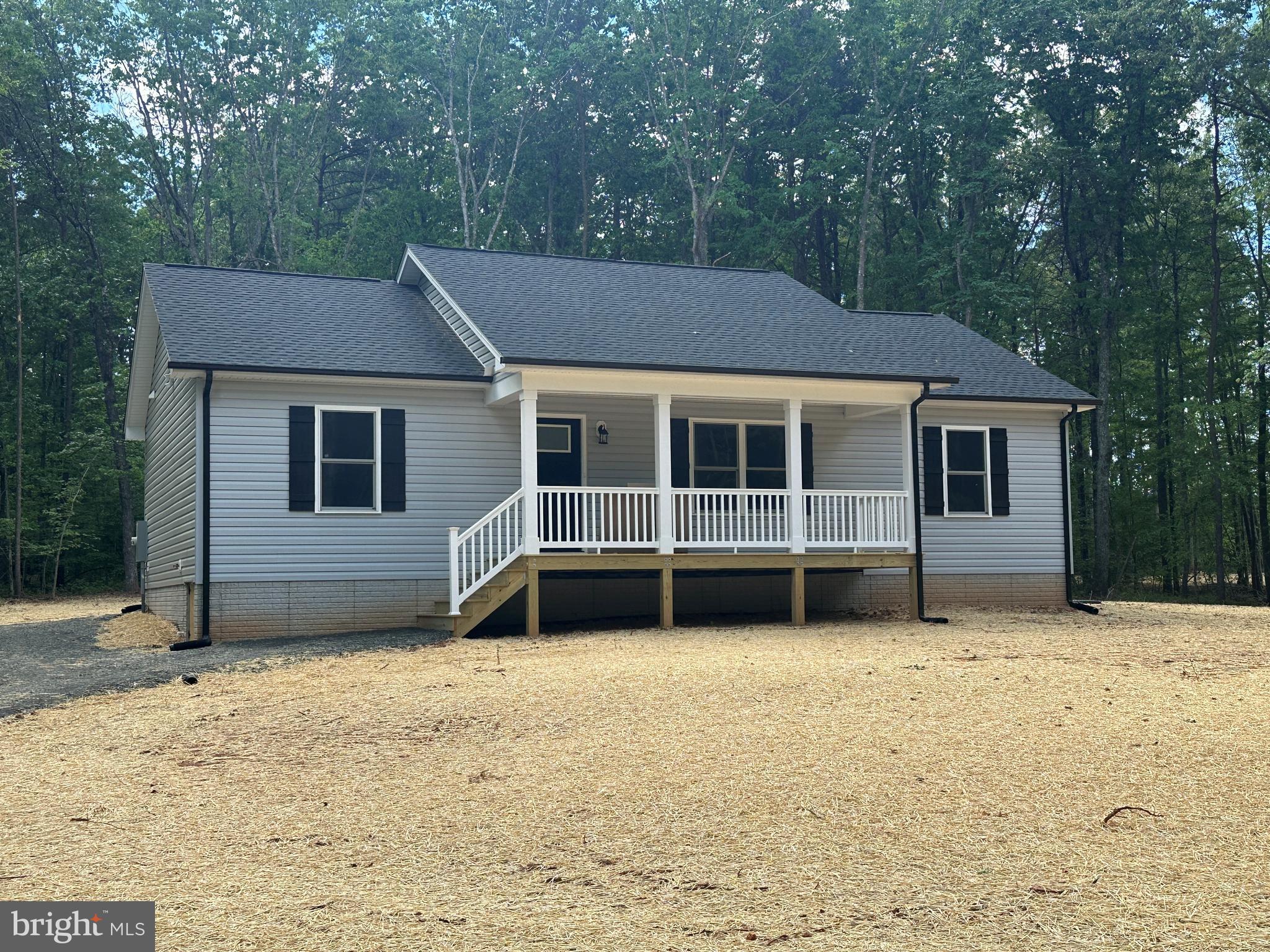 Beautiful Rambler Tucked Away on 2 Acres - Just Completed and ready for you! Open floor plan with vaulted ceiling in the Kitchen/Dining/Great Room area of the home. Rich LVP flooring throughout the entire home. Kitchen displays a large granite center island, gleaming white cabinetry, stainless steel appliances and double sink. Primary Suite complete with walk-in closet and Full Bath with double vanity. Two additional spacious Bedrooms balance out the opposite end of the home. Both Baths offer granite countertops and tub/shower combos. Thoughtfully designed Utility Room offers pantry, coat/storage closet and ample room for a full-sized washer and dryer. Sit for a bit on the covered front porch, adorned with metal pickets and easy to maintain vinyl railings. Relax on the rear deck or invite your friends/family for a backyard BBQ - plenty of space to enjoy! The black gutters/downspouts, shutters and door really make this charming home pop!!