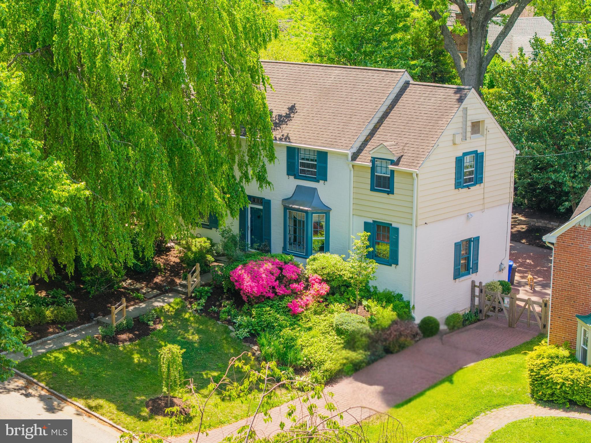 As you approach, this home feels like it's tucked into its own little oasis. The mature landscaping, graceful canopy overhead, and classic white brick exterior create a peaceful and inviting setting.

Step inside this classic center hall Colonial and you'll find a home that has been thoughtfully updated while preserving its original character. Fresh paint throughout and newly refinished random-width pegged oak floors complement timeless features like the spacious living room with its brick fireplace and custom built-in bookshelves, and a formal dining room that's equally suited for holiday gatherings or everyday meals.

The kitchen blends classic style with modern convenience, featuring flat-panel wood cabinetry, updated countertops, stainless steel appliances, and a sunny breakfast nook that's the perfect place to start your day. A newly added powder room on the first floor adds even more functionality.

Upstairs, you'll find three comfortable bedrooms, a dedicated home office, a hall bath, and a private ensuite bath in the primary bedroom.

The finished lower level expands your living space with a large family room featuring built-ins, a dry bar, and a convenient half bath, making it an ideal spot for entertaining, movie nights, or watching the big game. You'll also find the laundry area, generous storage, and interior access to the attached garage.

Additional highlights include 200-amp electrical service, two-zone heating, a whole-house generator, a newer rear deck, and a decorative stamped concrete driveway.

The finishing touch is the landscape itself. A magnificent Weeping American Beech, propagated from Curtis Arboretum, serves as the centerpiece of the front yard, creating a setting that's as memorable as the home itself. Situated on a quiet street with convenient access to Route 309, the Pennsylvania Turnpike, shopping, dining, and parks, this is a home that offers timeless charm, thoughtful updates, and an exceptional setting.