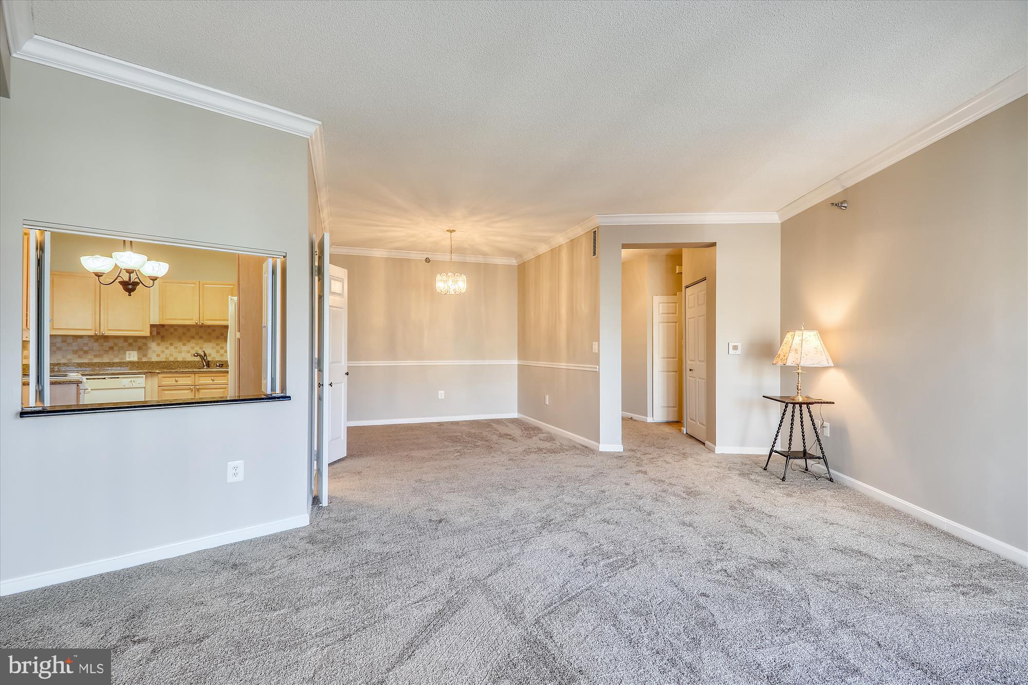 This sunlit two-bedroom, two-full bath condominium is nestled within the gated, adult living community of Leisure World in Turnberry Courts. Offering the perfect blend of comfort and convenience, this fourth-floor unit boasts an open floor plan, featuring a spacious living room with sliders to a sunroom, dining area and eat-in kitchen. Enjoy garage parking, an entry-level storage unit, neutral paint and new carpet throughout. With crown and chair rail molding, dishwasher, ample closet space and a laundry room, this home is move-in ready. Bathrooms with ceramic tile flooring and shower safety bars provide added comfort. The secured building features a welcoming lobby and central mail area. Indulge in Leisure World's abundant amenities, including restaurants, pools, tennis courts, a golf course, an exercise room, party rooms, and more. Perfectly situated near major thoroughfares, public transportation, shopping, and recreational activities, this home offers the ideal lifestyle. Don't miss this opportunity to make it yours!