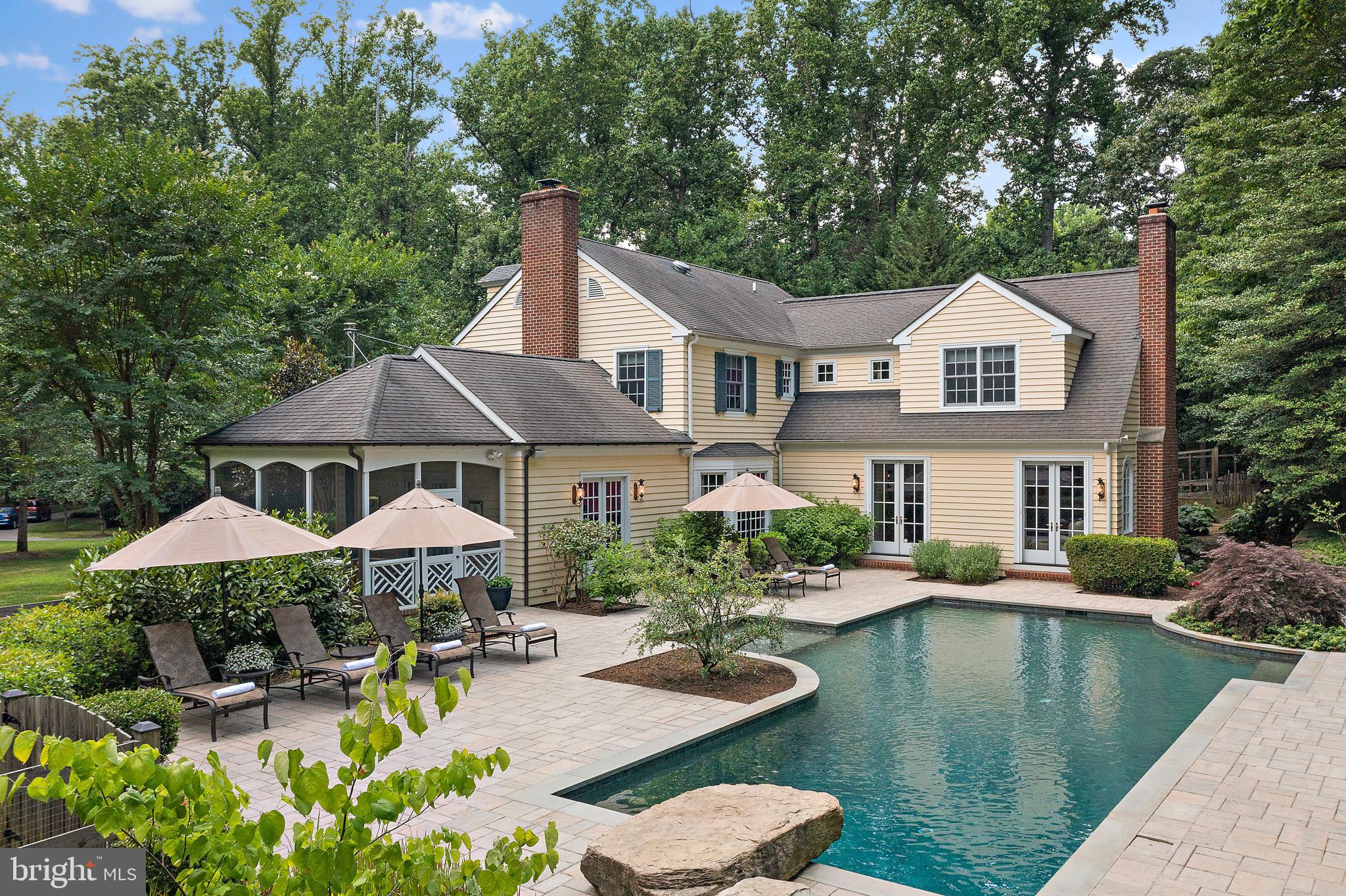 *Do not enter the driveway without an appointment.* Exceptional Colonial Estate in Secluded Cherrystone Community. Nestled on 2.45 private acres, this stately colonial home offers a peaceful retreat just ten minutes from downtown Annapolis. Surrounded by nature, the property features a beautifully designed heated saltwater pool and a spacious pavilion with a stained wood ceiling, outdoor kitchen, bar seating, fire pit, and standing seam roof (2017)—perfect for entertaining.

Inside, the home offers 6,000 finished square feet of well-appointed living space. A three-car garage connects to a charming mudroom, leading into an updated gourmet-kitchen with Thermador appliances and family room that overlooks the pool and wooded landscape. The versatile floor plan blends classic traditional elements with an open great-room featuring a fireplace, ideal for gathering.

The inviting brick veranda entry welcomes guests into a formal living room with a fireplace and dining room. A spacious study with built-in shelving offers flexibility as a home office or billiards room, with direct access to the pool and a screened porch with a wood stove for three-season enjoyment.

A distinctive feature of the home is its two staircases, including a curved, light-filled rear staircase leading to the expansive primary suite with a gas fireplace, vaulted ceiling, sitting area, marble 5-piece bathroom, and custom closet. The upper level also includes a second primary suite, a convenient laundry room, and a cedar closet. Each of the four bedrooms has an updated en-suite bath.

Additional highlights include a whole-house generator, brick chimneys, and meticulously maintained gardens that enhance the home’s charm and curb appeal. A rare blend of privacy, elegance, and functionality, this property is a true retreat.