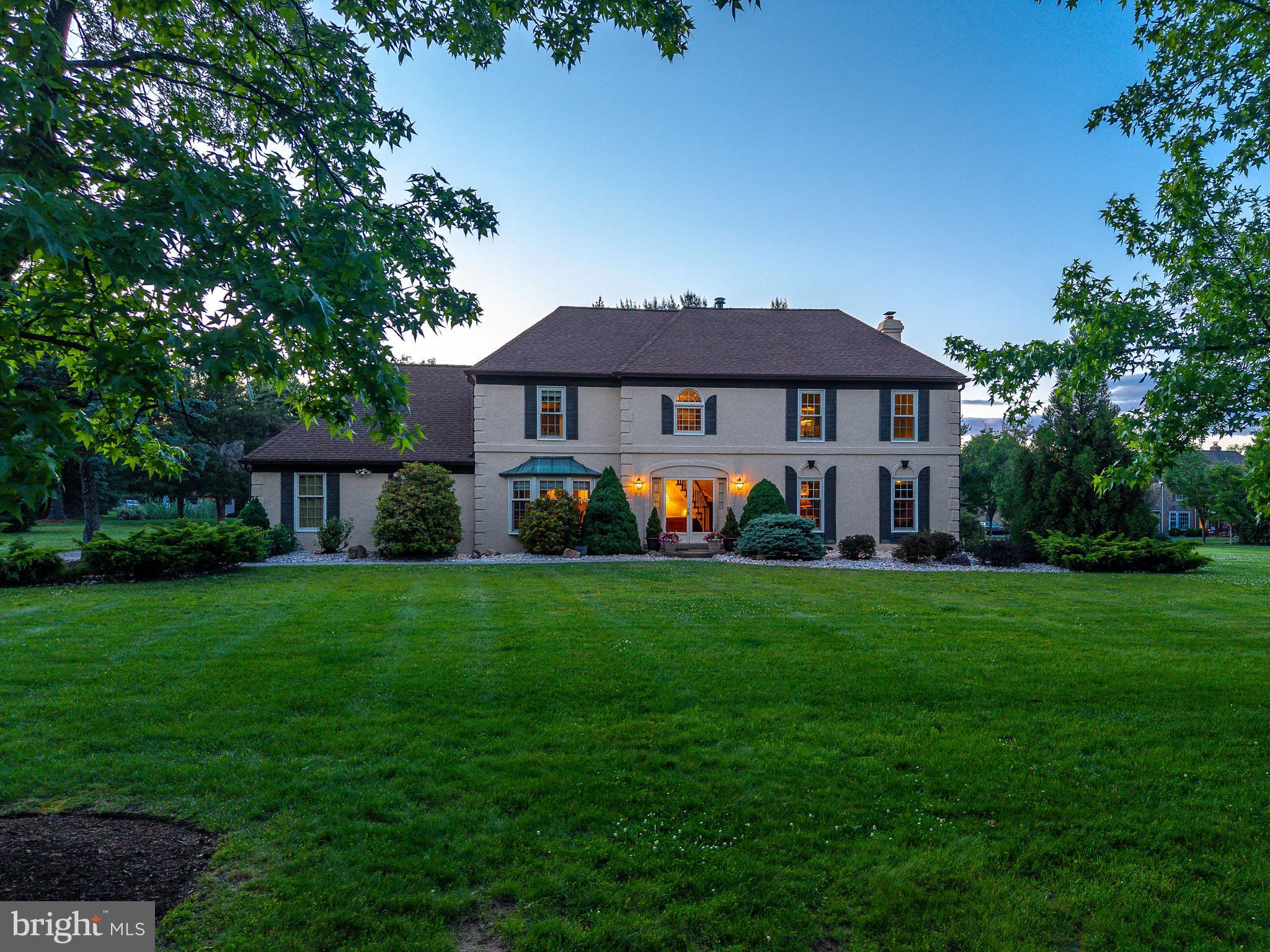 Nestled on a beautifully landscaped nearly one-acre parcel in sought-after Gwynedd Knoll, this exceptionally maintained French Provincial residence in a park-like setting offers the opportunity to enjoy one of Lower Gwynedd Township's most desirable neighborhoods within the award-winning Wissahickon School District. Mature trees, manicured grounds, and thoughtfully curated landscaping create a picturesque setting, while the home's convenient location provides easy access to Routes 202 and 309, Spring House Shopping Center, Whole Foods, Starbucks, CVS, Giant as well as the Ambler Area YMCA, and the vibrant shops and restaurants of nearby Ambler. One of Gwynedd Knoll's most cherished attributes is its walkability. Whether enjoying an evening stroll, walking the dog, or working toward that daily 10,000-step goal, residents appreciate the neighborhood's quiet streets, mature surroundings, and welcoming sense of community. Lovingly maintained by its original owners since 1986, the home reflects decades of pride in ownership and thoughtful investment. Significant improvements include replacement windows throughout in 2019, all new garage doors, updated mechanical systems, and an exterior coating system utilizing breathable epoxy paint designed to enhance the home's protection from moisture intrusion while preserving the integrity of the exterior. A welcoming center hall foyer introduces a traditional floor plan designed for both everyday living and entertainment. Formal living and dining rooms provide inviting gathering spaces, while the beautifully renovated kitchen serves as the heart of the home with quality cabinetry, a granite-topped center island, hand-painted porcelain tile backsplash, coffee station, premium appliances, and abundant workspace. Open to the adjacent family room with fireplace, this comfortable space is ideal for both relaxing and entertaining. The main level also includes a convenient laundry area, powder room, and access to the meticulously maintained 3-car garage featuring epoxy-coated flooring, a workbench, storage shelves and a pegboard wall for tools.  Upstairs, the spacious owner's suite includes a sitting room, expansive walk-in closet, dressing area, and private bathroom. Three additional bedrooms share a well-maintained hall bathroom. The partially finished lower level provides flexible space for recreation, hobbies, fitness and entertaining.  The remaining, substantial unfinished storage space offers exceptional practicality and metal shelving for organization. Outdoor living is equally appealing with a level, park-like backyard, mature landscaping, and a charming patio with awning—perfect for morning coffee, bird watching, summer entertaining, or al fresco dining. The expansive rear yard provides ample space for gardening, outdoor games, or simply enjoying the peaceful surroundings. For buyers seeking a beautifully maintained home with an updated kitchen, replacement windows, roof, updated systems, exceptional outdoor space, and the opportunity to personalize select finishes over time, this Gwynedd Knoll residence presents an exceptional opportunity in one of Montgomery County's most established and desirable communities.