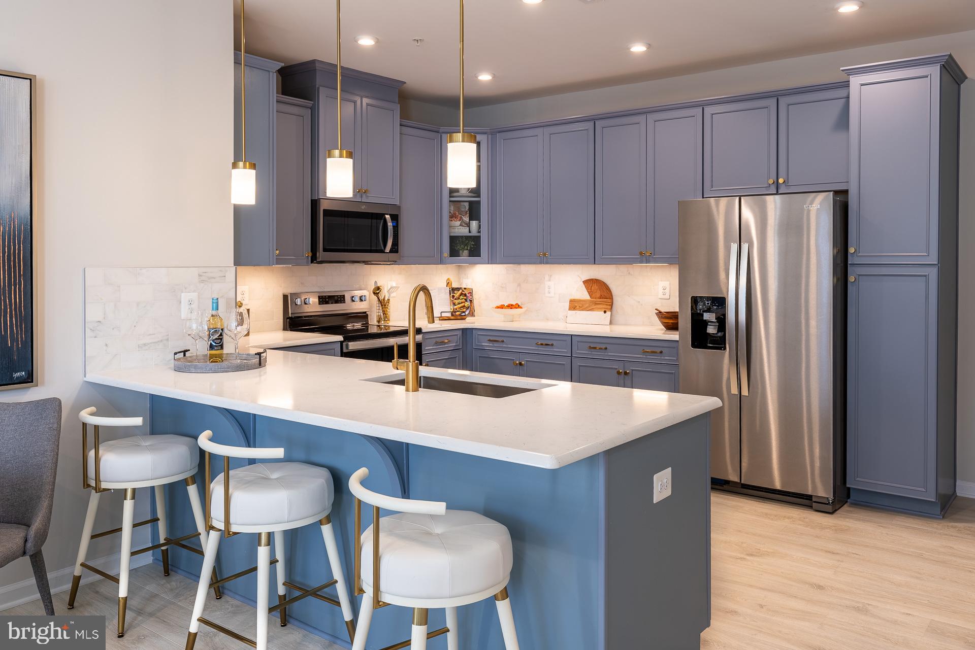 Welcome Center now open at Montgomery counties newest community, come tour today! Welcome home to the Riva, a thoughtfully designed lower‑level, 2‑story townhome style condo with a 1‑car garage, nestled in the vibrant One Central community in Gaithersburg. From the moment you step inside, you’ll feel how this home blends comfort, style, and convenience in all the right ways. The open kitchen is truly the heart of the home—featuring abundant cabinetry, a designer tile backsplash, generous counter space, Whirlpool® stainless steel appliances, luminous pendant lighting, and beautiful quartz countertops that make cooking and gathering feel effortless. It flows seamlessly into the bright, welcoming great room, where natural light fills the space and creates a warm, inviting atmosphere. Just off the great room, a tucked‑away powder room adds everyday convenience. Upstairs, life gets even easier with a centrally located laundry room and a flexible layout that lets you choose what fits your lifestyle best: three bedrooms or two bedrooms and a loft. The primary suite becomes your personal retreat, complete with a spacious walk‑in closet and a serene bath offering a private water closet, dual sinks with quartz countertops, and a large walk‑in shower. This is a home designed to support your everyday moments—big and small—with ease, warmth, and style.