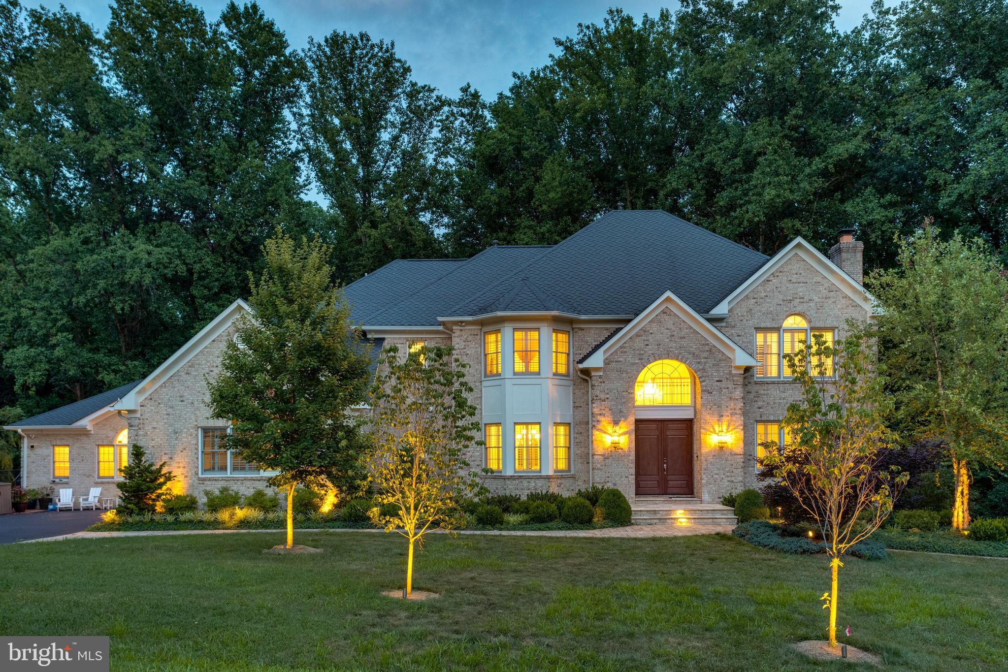 DON'T MISS THE WALK-THROUGH VIDEO** This spectacular custom all brick colonial includes an AMAZING CONNECTED BUT PRIVATE 2 LEVEL IN LAW SUITE WITH OVER 3000SQFT, FEATURING A PRIMARY BEDROOM, TWO AND A HALF BATHS, CATHEDRAL CEILINGED SECONDARY GREAT ROOM, LARGE PRIVATE KITCHEN, WORK-STATION HUB, PRIVATE ENTRY, PLUS ITS OWN LOWER LEVEL WITH A FINISHED REC ROOM, AND SECOND BEDROOM SO EVEN THE IN-LAWS CAN HAVE VISITING GUESTS AND FAMILY MEMBERS. ***Almost $1,200,000 IN UPGRADES throughout the last 10 years! Style, size, incomparable quality, glamour, spaciousness, and location are all a part of a features list that would fill a novel. INCLUDING, **Motorized shades, Timed LED recessing lights system, Sonos system with ceiling speakers, Plantation shutters, & MORE! There is a **2-STORY FOYER with curved staircase,  gorgeous **TOTALLY RENOVATED CHEFS CALIBER ISLAND KITCHEN with SS appliances, and dining area opening to a **LIGHT FILLED VISTA ROOM WITH GLASS WALLS AND FULL GLASS SOLARIUM CEILING. The **2-STORY GREAT ROOM is light filled with vista windows overlooking the decks and valley below. The **MULTI-PURPOSE SERVICE ROOM  with island is used as the FAMILY FOYER with individual cubbies, work stations, laundry & pet grooming! The upper level features **UPDATED BATHS, 3 LARGE BEDROOM plus PRIMARY SUITE with double sided fireplace. The **LOWER LEVEL  is complete with a rec room, EXTRA BEDROOM, exercise area, REFRESHMENT KITCHEN plus access to the WALK OUT PATIO!