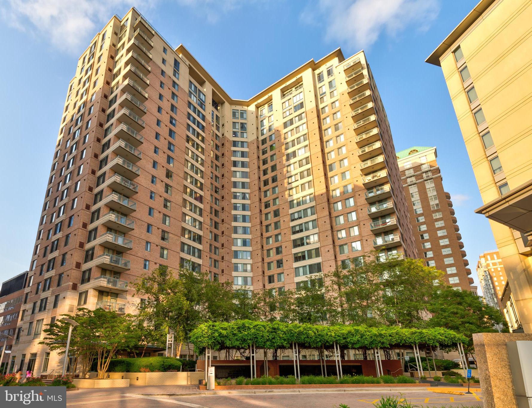 Live in the center of the thriving Ballston area in The Continental. This spacious, two en-suite, condo apartment exemplifies modern, amenity-rich living in a desirable neighborhood on the corridor of Arlington. This home features an open-concept kitchen and living space with dark, granite countertops and stainless steel appliances, accented by a tasteful backsplash. Hardwood floors provide a classic feel, leading to full-length plantation shutters over large windows. A street view of Ballston in the foreground and a treed, hill view in the background can be seen from all windowed spaces. With walk-in closets and generous, updated bathroom spaces, there's no corner cut on comfort in the home. The Continental features abundant amenities, including a fitness room with weights and workout equipment, a business center, tiered movie theater, meeting and event spaces, a pool, and a rooftop deck with panoramic views of DC and Northern Virginia. One garage parking space comes with this home. This fantastic home will not last. Home is available in early June!