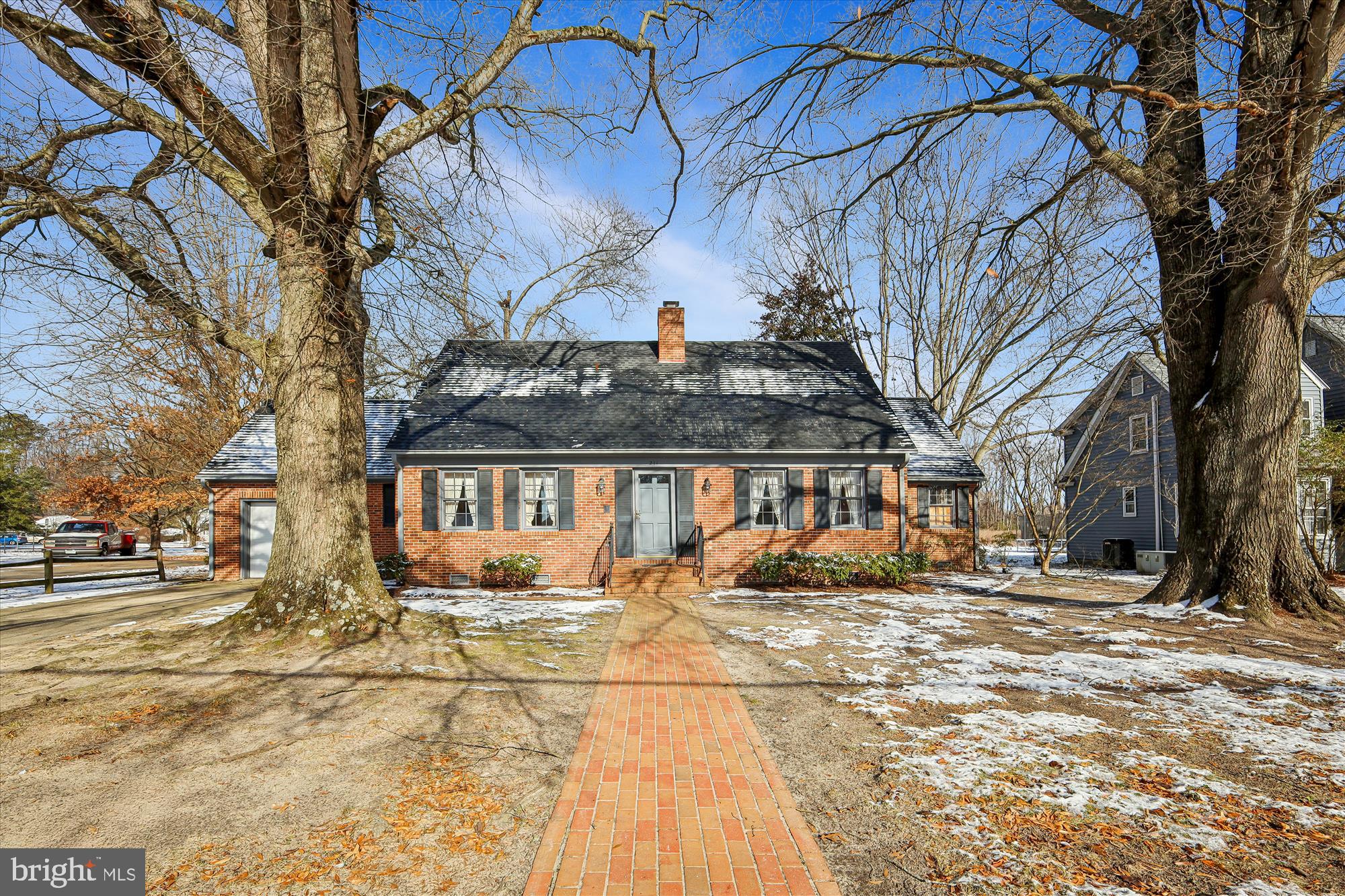 Welcome to 211 Bloomingdale Ave. This custom‑built Brick Williamsburg‑style colonial showcases true craftsmanship, featuring beautiful hardwood floors throughout, custom built‑ins, and detailed moldings. The spacious living room offers an inviting wood‑burning fireplace, while the large great room with its vaulted ceiling provides flexible living space and could easily be converted into a third bedroom if desired.

The bright, well‑appointed kitchen is ideal for anyone who loves to cook, offering ample room for a kitchen table and direct access to a separate formal dining room—perfect for hosting guests. A convenient half bath is located on the main level, with a full bath upstairs along with two generously sized bedrooms and a large walk‑in storage area.

Outside, a concrete driveway leads to an attached garage.  There is a brick walkway from house to the town sidewalk.  Spacious private backyard with mature trees and a newer roof.  This home is truly move‑in ready and waiting for you to enjoy.
