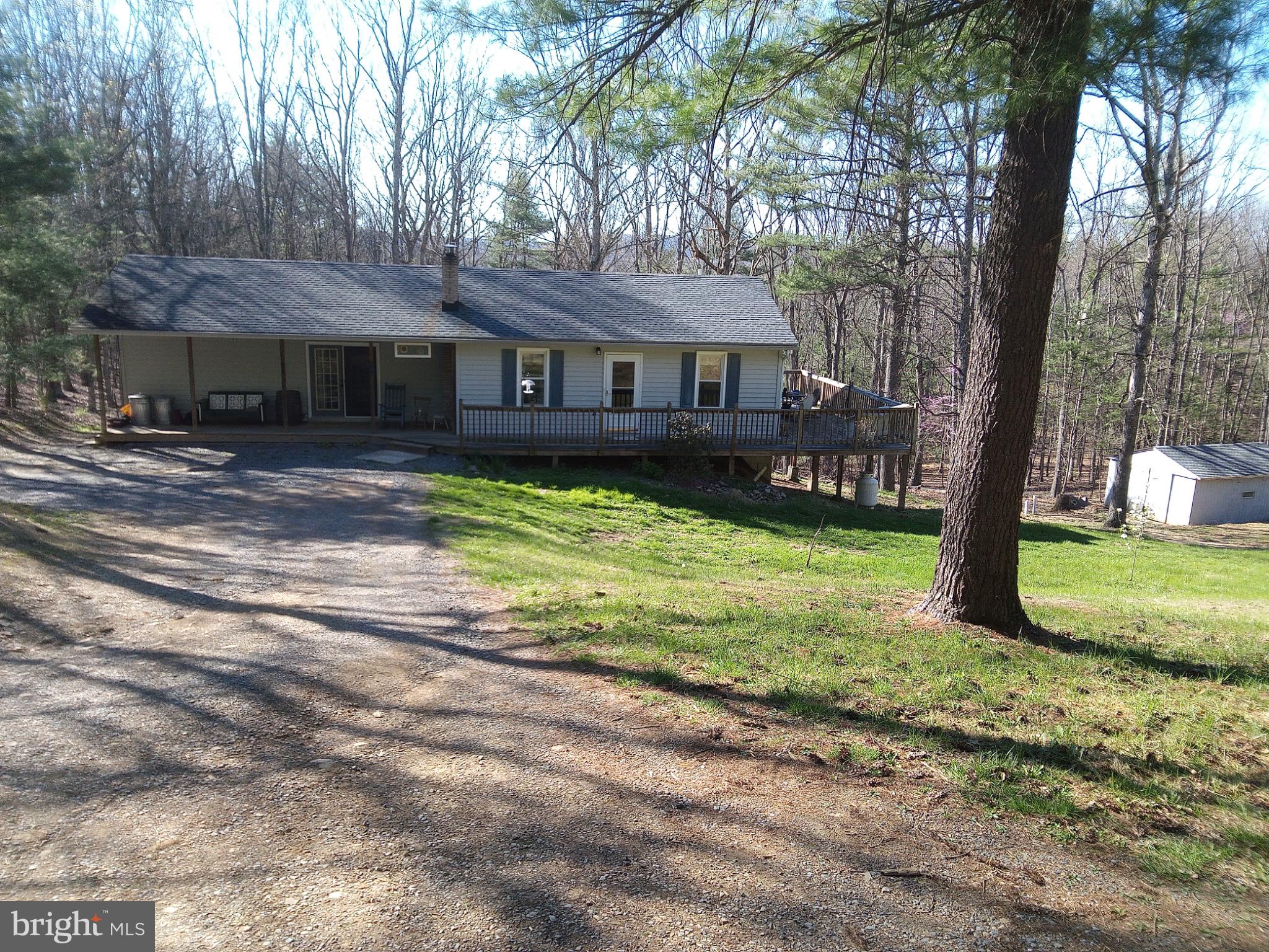 Looking to get away from the hustle and bustle. This is the home. Situated 1.2 acres of a wooded lot and practically no traffic. Cooled in the summer by shade trees, warm in the winter by a cozy wood stove. Roof is only 5 rears old. Large master bedroom with private bath. Huge family room on lower walk out level. Attached and detached garage. Whether a weekend get away or year round home, this is a great location. Near Green Ridge State Forest, Rocky Gap Resort with Campground, Lake, Golf Course and Casino. Only minutes from Cumberland and about an hour from Deep Creek Lake. Come check it out.