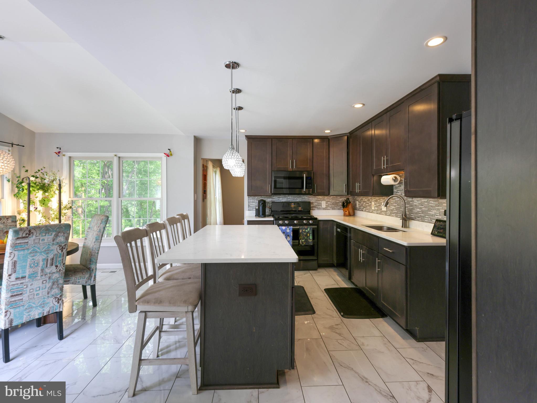 $76,000 in recent upgrades!!
Every major detail has been addressed for a seamless move-in:
•  New Trex deck
 • New backyard fencing
• Brand-new A/C system
• New high-efficiency LG large-capacity laundry
• New dimmable recessed lighting installed in every room
• New built-in power and USB in kitchen island

Welcome to this striking colonial, perfectly positioned on a coveted corner lot in Gaithersburg’s premier Meadowvale neighborhood. With over 3,000 square feet of meticulously maintained living space across three finished levels, this residence offers incredible peace of mind and balances traditional charm with high-end, functional upgrades.

The experience begins in the two-story foyer, a bright introduction to the home’s open and airy floor plan. The expansive family room serves as the home's anchor, featuring rich hardwood floors and a wood-burning fireplace—an ideal setting for quiet weeknights or lively weekend gatherings.

At the heart of the home is the fully renovated kitchen, designed for both the home cook and the frequent host. Features include:
• A large granite island that comfortably seats four and extra cabinets
•  Premium stainless steel appliances
• Custom cabinetry and a large shelved pantry closet
• A sun-drenched eat-in area that flows naturally to the outdoors for a seamless cooking and serving experience.

Transition to the new upper-level Trex deck, engineered for beauty and long-term durability. This premium composite material ensures years of enjoyment with minimal maintenance, providing the perfect platform to capture unobstructed sunset views. Below, the massive backyard offers a sense of quiet seclusion rarely found in the area. Backing to mature trees and secured by a brand-new fence, this private lawn provides a scenic backdrop for relaxation, complete with a dedicated storage shed.

The upper level is headlined by the primary suite, where cathedral ceilings and customizable recessed lighting lend a sense of volume and grace. The en-suite bathroom serves as a personal spa, featuring a jetted soaking tub, dual vanities, and premium finishes. Three additional generously sized bedrooms—each equipped with new lighting—provide the versatility needed for family, guests, or a dedicated home office.
The finished walkout lower level further expands the footprint, offering a large open recreation area, a private fifth bedroom, and a full third bath—ideal for guests or an au pair suite.

Located in one of Gaithersburg’s most accessible pockets, you are just 1.5 miles from the RIO Washingtonian Center, Flower Hill Shopping, and the Montgomery County Fairgrounds. Commuting is effortless with immediate access to I-270, ICC/MD-200, and the MARC train, while local aquatic centers and greenways keep recreation right at your doorstep.

This isn't just a house; it’s a thoughtfully upgraded home designed for those who value both community and a private place to recharge.

Property is equipped with video surveillance.  Audio recording devices are disabled during showings and open houses.