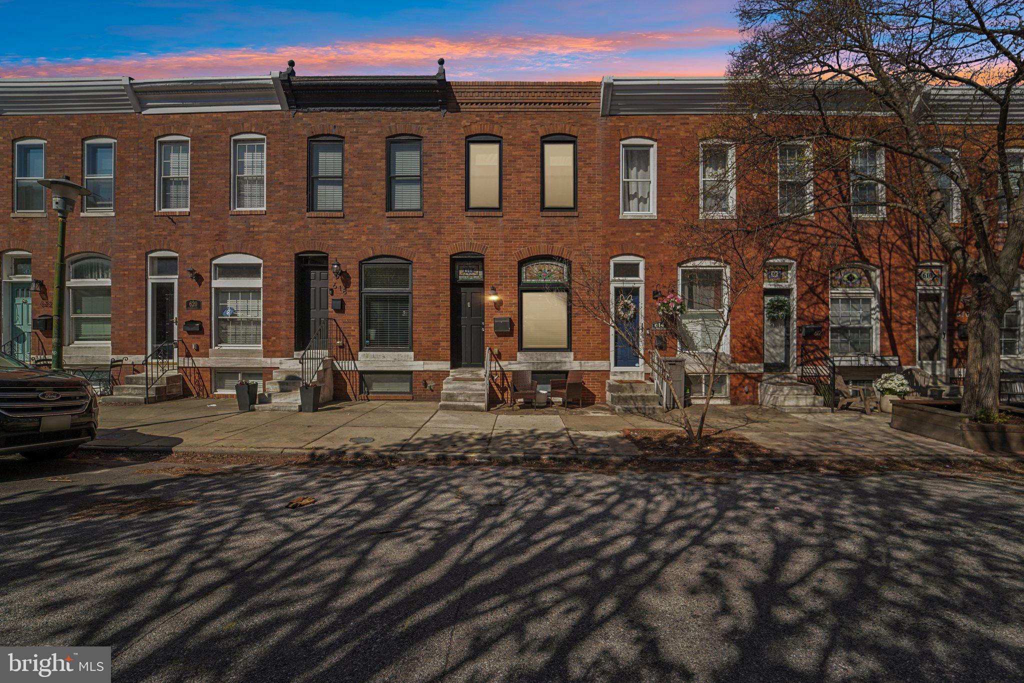 This beautifully  home features an open concept main level with gleaming hardwood floors and exposed brick walls, creating a warm and inviting atmosphere. The spacious kitchen is a true highlight, complete with stainless steel appliances, granite countertops, cherry cabinetry, tile backsplash, and a center island perfect for entertaining. Sliding glass doors lead directly to a brand new Trex deck and private patio - ideal for outdoor dining and relaxation. Upstairs, you’ll find two generously sized bedrooms, each with its own en-suite bathroom, offering comfort and privacy. The fully finished lower level includes a third bedroom and an additional full bath, providing flexible living space for guests, a home office, or more. Additional upgrades include a new HVAC system, new rear windows, new sliding glass door and roof replaced 2025. Located just steps from Canton Square, Patterson Park, waterfront attractions, shops, dining, and easy commuter routes, this move-in ready home offers the perfect blend of style, convenience, and city living. Don’t miss it!