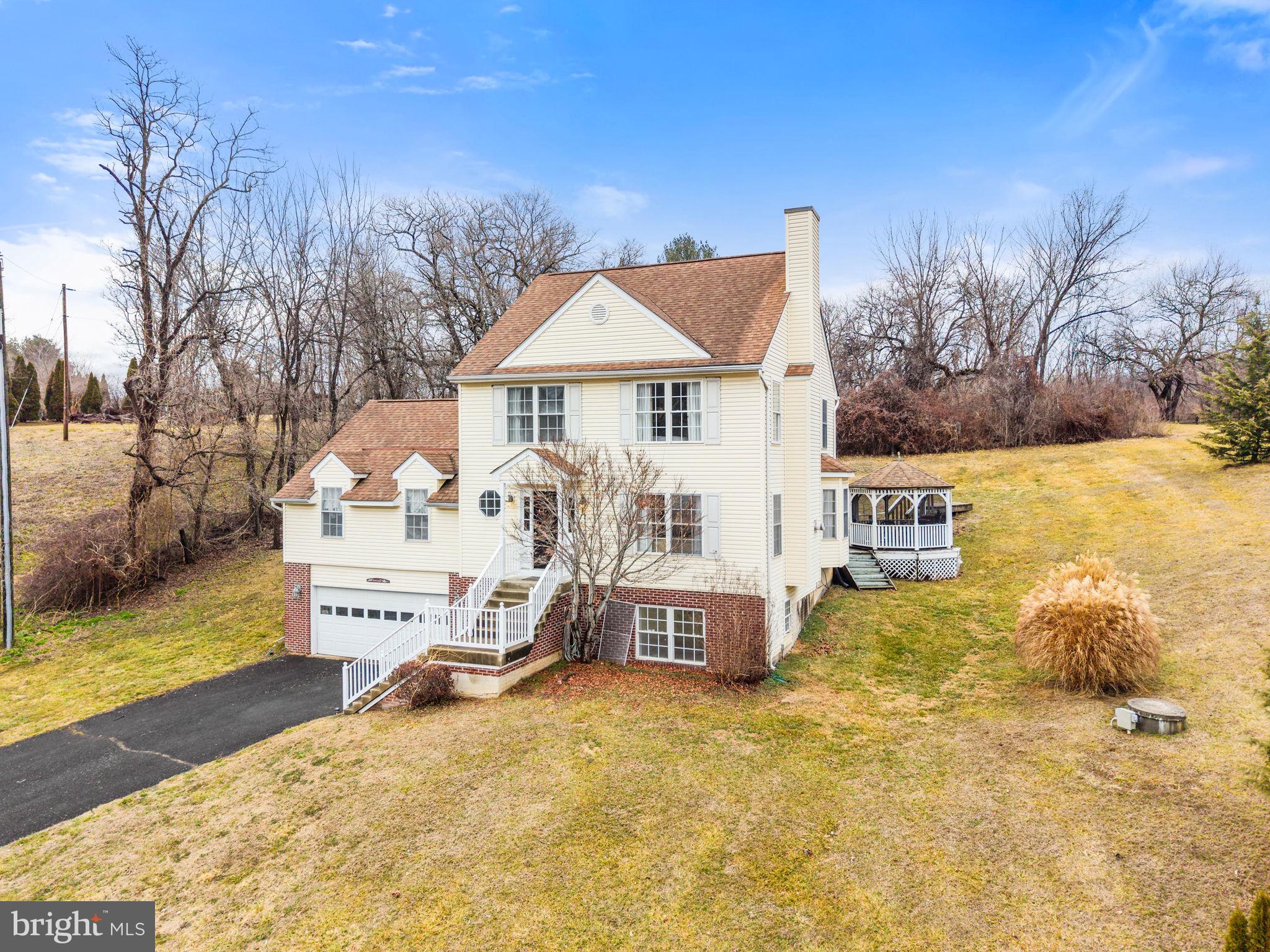NEW PRICE for this traditional home with acreage, nice views and an easy commuter access? This is it.  Plus there is a separate living area for extended family or friends, live-in help, teenagers or to use as a great room/media room, etc. The walk-out lower level is finished with three rooms and a full bathroom. The floor plan accommodates a variety of life styles.
The main floor of the house features a  sun-filled living room with gas fireplace, dining room with French doors leading to the deck and gazebo, kitchen with pantry, half bathroom plus a large primary suite with attached, full bathroom. The primary suite is large enough for a king size bed with plenty of room for a sitting area or office. It has vaulted ceilings, a large walk-in closet and two window alcoves. There are wood floors throughout the main level except in the primary suite which is carpeted. 
The upper level has two+ bedrooms, a full bath with shower/tub and separated vanity area from the shower and toilet. The bathroom can be accessed from one of the bedrooms and from the hallway. There is a smaller room on this level  currently being used as the laundry room. It could be converted into another full bathroom. It has a walk-in closet and pull down stairs to the attic.  There is  Excellent cell phone and Internet reception here at this house!
Enjoy mountain views and look over parts historic Markham Village from the front porch. The rear deck with screened-in gazebo are perfect for outdoor meals and entertaining. The backyard goes way back and is level . Enjoy playing horse shoes, croquet, swings and sandboxes or practice your golf skills there.

Parts of the quaint and historic village of Markham are across the street and scenic, Goose Creek adds to the charm and ambience of the area. There are several wineries and apple orchards very close by. Drive along scenic Rt. 55, John Marshall Hwy. It was the main East-West road before I-66 was built. Travelling Westward towards Front Royal, stop at the famous Apple House, restaurant  and gift shop in Linden. Travel Eastward all the way to Gainesville and enjoy the small towns and businesses along the way. This is a great location, 10 minutes to Marshall, 15 minutes to Haymarket, 20 minutes to Warrenton, 10 minutes to Front Royal and about 30 minutes to Winchester. Depending on traffic, you could be in Arlington/DC in less than 1 hour.
The house can be sold fully or partially furnished. Dining room table and drop leaf table in dining room  are excluded.