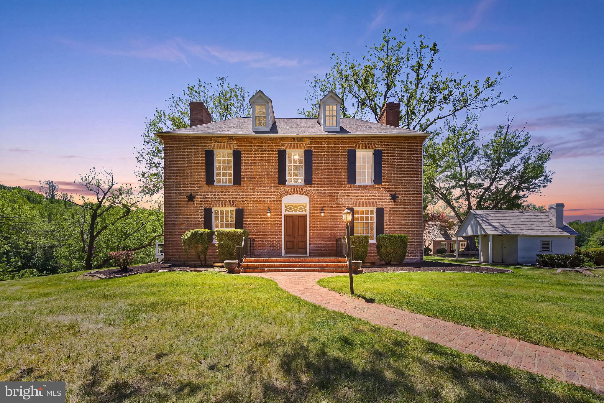 Some homes tell a story. Hartwood House preserves an era like few others in Virginia
and well beyond! Located at 1791 Warrenton Road, this extraordinary historic estate
traces its roots to the early 1800s and stands today as one of Stafford County’s most
remarkable private residences.
Set across 34 +/- acres of rolling countryside, the property centers around the
original brick manor house, a residence that has witnessed generations of Virginia
history unfold beyond its windows. Built by Irish immigrant William Irvine, Hartwood
House once anchored a much larger estate spanning thousands of acres. Through the
Civil War, periods of transition and an extensive restoration effort that brought the home
back from the brink, the property has endured with a sense of permanence rarely found
today.
The estate encompasses a beautifully restored main residence of finished living space,
along with a separate manor house that provides additional accommodations and
flexibility. Together, the two structures create a setting suited for multigenerational living,
guest quarters, creative pursuits or the stewardship of a truly singular Virginia landmark.
The approach sets the tone immediately. A hedge-bordered drive reveals the stately
brick façade, where symmetry, historic character and timeless craftsmanship create a
memorable first impression. Inside, original details remain at the forefront. Exposed
brick, heart pine floors, pure wood elements, period fireplaces and deep-set windows
speak to the home's heritage while thoughtful updates allow it to function comfortably for
modern life.
Formal living and dining rooms provide elegant gathering spaces, each framed by
historic architectural details and abundant natural light. A richly appointed library offers
a quieter retreat (including a half-bath!), with floor-to-ceiling custom built-ins and views
stretching across the surrounding grounds. The kitchen serves as another heart of the
home with a massive marble-draped island and double-oven within a brick wall (wow!),
designed for everyday living and entertaining alike.
Upstairs, the primary suite occupies a substantial footprint with access to multiple closet
and storage nooks. Additional bedrooms retain the character and proportions expected
of such a historic residence, while attic and storage spaces offer opportunities for future
expansion or preservation-minded use.
Beyond the main house, the separate manor residence contributes an entirely different
layer of versatility. Complete with its own living room, kitchen, bedroom, flex space and
spacious deck, it provides privacy for guests, extended family or potential caretakers
while remaining connected to the larger estate.
The grounds themselves are every bit as compelling as the structures. Open pasture,
mature trees, historic outbuildings and wide stretches of lawn create a landscape that
changes oh-so-beautifully with the seasons. Whether hosting gatherings beneath
centuries-old trees, enjoying quiet mornings overlooking the countryside or simply
appreciating the total sense of space, the property offers a setting that is increasingly
difficult to find.
History enthusiasts will appreciate the estate’s documented Civil War connections,
including periods when both Confederate and Union forces occupied the property.
Stories tied to figures such as Fitzhugh Lee, Wade Hampton and the Irvine family
remain woven into the fabric of the home, creating a living connection to Virginia’s past
that extends far beyond preserved architecture.
There are numerous dining, shopping, grocery and recreation selections along/just off Route 17 within 5 minutes; I-95 access within 10 minutes and the heart of Fredericksburg within 15 minutes. 
The home is served by Stafford County Public Schools.
For the next steward of this historic landmark, 1791 Warrenton Road equates to an
opportunity for architectural beauty, acreage, history and everyday livability all in one.
Book your showing today!