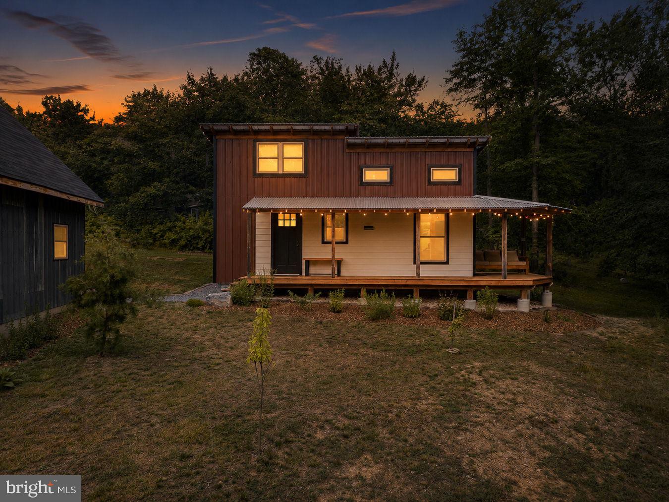Discover the perfect blend of luxury, simplicity, and privacy at 310 Ward Drive in Bunker Hill, WV. This beautifully custom-built one-bedroom, one-bath home offers the charm and efficiency of a tiny home while providing the comfort and independence of private well and septic systems.
Situated on two peaceful acres, this one-of-a-kind property offers the ideal setting for those seeking a tranquil lifestyle without sacrificing quality or craftsmanship. Whether you're looking for a full-time residence, a weekend getaway, or an investment opportunity, this exceptional home delivers modern comfort in a picturesque country setting.
