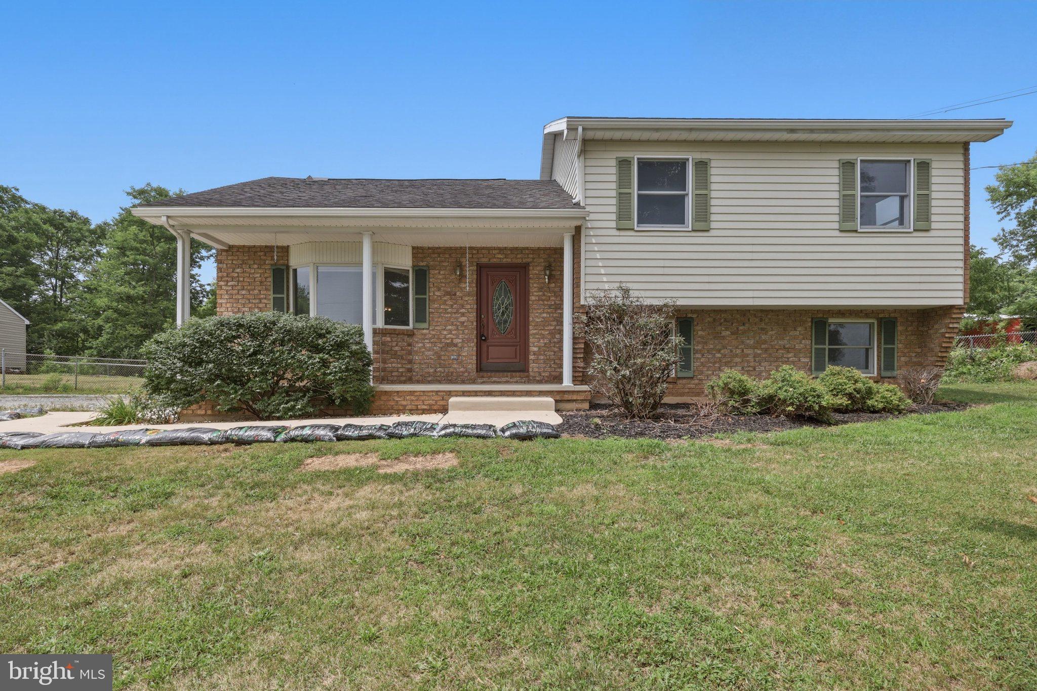 Charming and well-maintained split-level home offering a comfortable and functional layout. The main level features durable luxury vinyl plank flooring and a bright, open living and dining area highlighted by a bay window that fills the space with natural light. Sliding doors lead to the sunroom, creating the perfect setting for relaxing or entertaining year-round.The updated kitchen is designed with both style and convenience in mind, featuring quartz countertops, tile back splash,  42-inch cabinetry with pull-out drawers, and a pantry.
The upper level includes three bedrooms, including a primary bedroom with a private half bath, along with a full hall bath serving the additional bedrooms. The lower level offers a welcoming family room, providing additional living space for gatherings, hobbies, or recreation, as well as a convenient laundry area. with a door to the rear yard. Outside you will find two storage sheds (one with electric) offering plenty of space for tools, equipment, and seasonal items and a wood furnace that heats the house like a charm! This home combines modern updates with everyday comfort in a country setting. Views for days!!