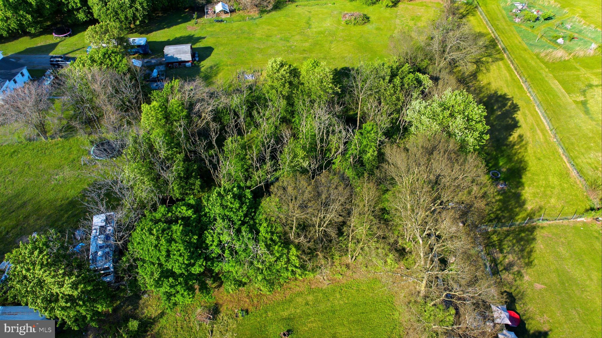 Secluded wooded lot on nearly half an acre in desired Bedington location, ready to build. This 0.48-acre unimproved lot offers a blank canvas surrounded by mature trees, set back for added privacy and a peaceful feel. Plenty of space for a custom home, outdoor living, or a private retreat. Public water is available for hookup and runs along the property, with availability verified through the county. Enjoy a natural setting with minimal through traffic while still being conveniently located near I-81 and Spring Mills shopping and dining. A great opportunity to build with space, privacy, and flexibility.
