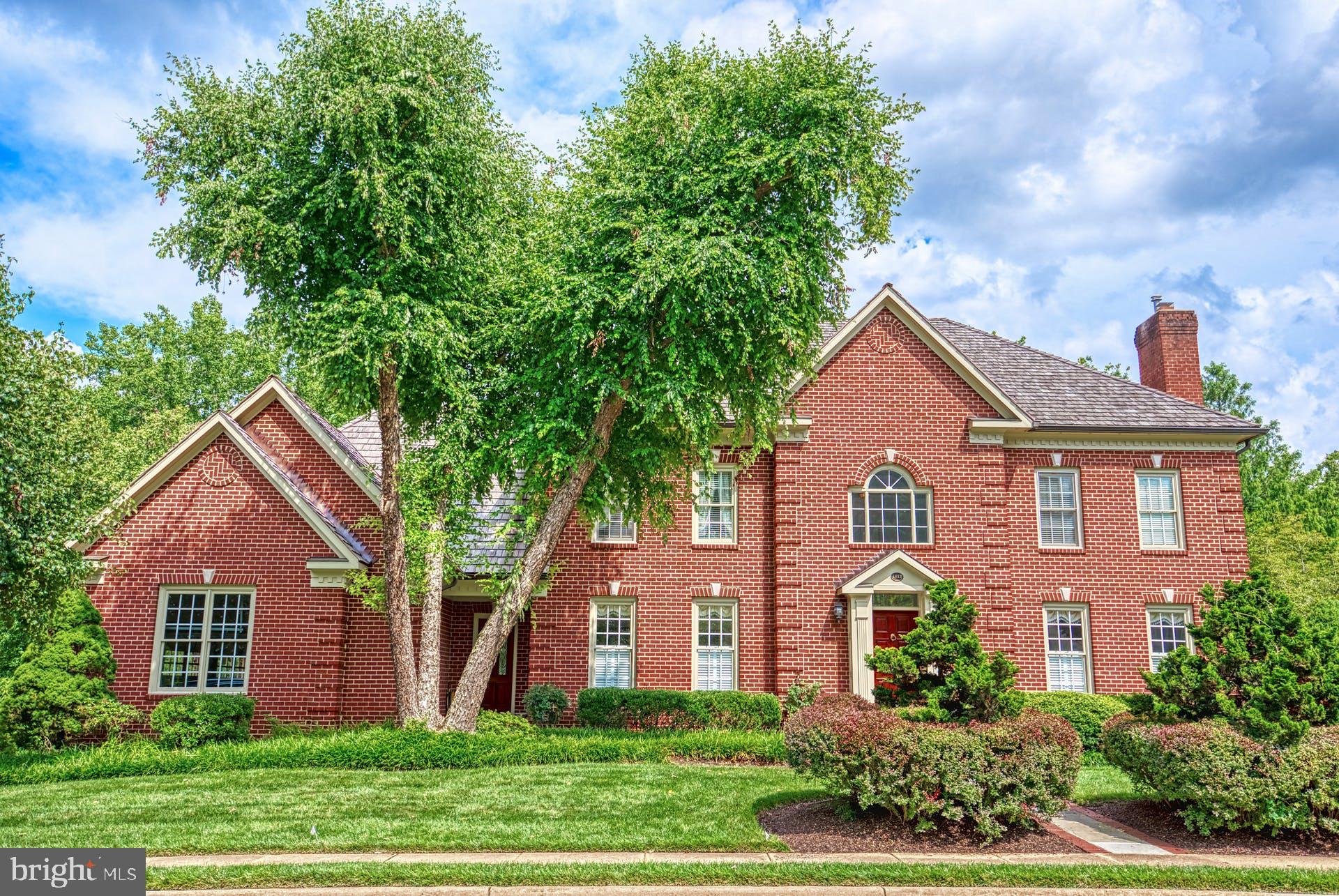 Stately ALL-BRICK Georgian colonial on a premium, private lot backing to  PARKLAND is impeccably maintained and beautifully appointed. Built to the high standards of acclaimed and award-winning builder, Randolph Williams in 1993, noteworthy and elegant details abound from the soaring, 2-story Marble Foyer to Dual Staircases and three  Fireplaces. This 3-CAR, side-load garage home boasts nearly 6,800 Square fFet of space inclusive of 4 generously-sized bedrooms on the upper level, a main level office (may easily convert to a bedroom should the need arise) and a lower level guest suite. 
The main level is open and timeless with wide Doorways, Hardwood Floors, generous dining and living rooms with Wainscoting, Crown Molding and beautiful Millwork (including the mahogany fireplace in the living room) & solid wood doors throughout. The main level office, allows access to the deck overlooking the pastoral back yard. And, the central family room boasts a cozy rustic stone fireplace flanked by twin French Doors to the larger of the two Decks. Adjacent is the kitchen with a convenient butler’s pantry – both appointed with quality Rutt Wood Cabinets and updated Quartz Countertops. The kitchen also hosts an island with storage and seating, newer Appliances and a cheery breakfast room with its own small deck --perfect for enjoying a cup of afternoon tea or watching wildlife frolic with morning coffee. The main level laundry room doubles as a mud room with quick access directly outside or to the garage. 
Upstairs, accessed from either the front or rear staircase, are spacious Bedrooms with upgraded carpet and pad, fresh paint and beautiful views from the windows – two bedrooms share a bathroom, another is an en-suite and the primary bedroom, with a tray ceiling, his and hers walk-in closets and an updated bathroom completes this level.  The lower level, surprising with 9’ ceilings, hosts a bonus or guest room with an adjacent full bathroom, several storage rooms and a bright recreation room with the 3rd fireplace and French doors to the ample slate patio. Pool Table in the lower level will Convey.  Two-zone HVAC (replaced in 2019 and 2016) keep the home very comfortable. The cedar shake roof (replaced in 2016) will look lovely for years to come.   Added Feature:  6-zone irrigation system.  The pride-of-ownership is obvious throughout this elegant and beautifully kept home.  ** FLOOR PLANS AND PLAT IN THE DOCUMENT PORTAL**