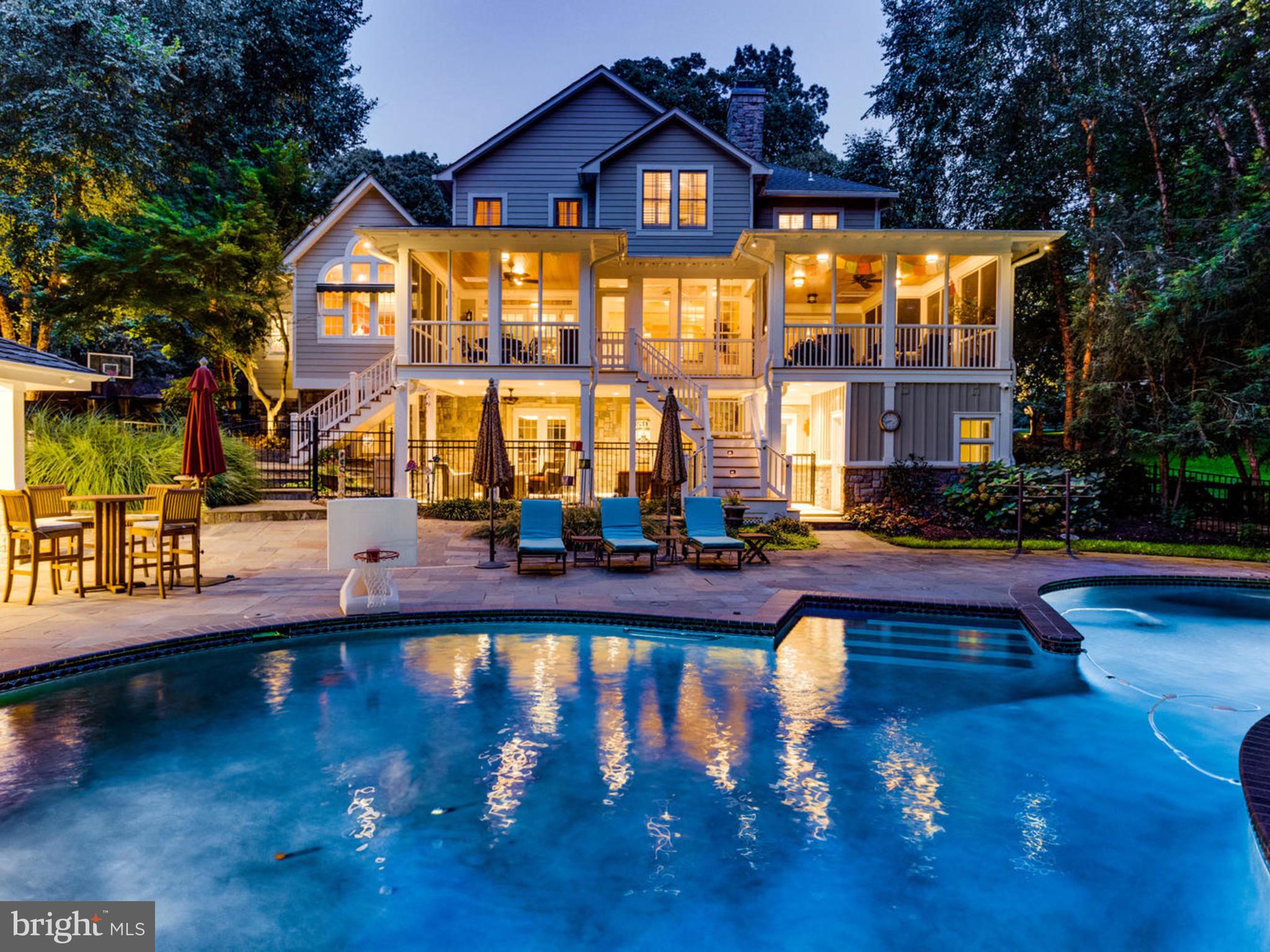 This sprawling Falls Church luxury estate property (only 15 mins to Amazon HQ2 and the D.C. line) is situated on a  private 2.3+ acre / 100,000+ sq ft lot and showcases a Craftsman-style cedar shake Farm House accentuated by immaculate outdoor & secluded spaces.  Entertain outdoors or treat yourself to a staycation at home and in style around the 800 sq ft heated pool (w/ new heater).  The expansive pool deck features a custom stone poolside cabana house and covered, outdoor kitchen & bar, each equipped with plasma TVs. Adjacent to the pool deck outside is a conditioned changing room / full bath complete with a custom-tiled shower for guests. Host an outdoor dinner party inside the massive addition designed in 2010 by Moser Architects: a  1,000 sq ft screened-in, three-season Trex Deck lounge and dining area that walks into the main home through three separate sets of glass French doors. The sprawling, fully-fenced grounds offer mature landscaping with a meticulous design plan and extensive man made drainage improvements.  The grounds include built-in, automated lighting and underground irrigation sprinkler systems for the many garden beds, flat open spaces to exercise and circuit train, and a fully-equipped playground.  An entrance drive-in with paddock fencing opens to a circular driveway with custom stone pavers and a handsome brick retaining wall for front-of-house parking.  The 3 car attached garage bay can house any combination of vehicles with an extended driveway pad outside for a boat, with direct access into the mudroom and laundry area.  Out front, the inviting, covered front porch opens into the two-story foyer with a cascading, curved staircase next to the front sitting parlor.  The interior of the home combines function (details such as wooden plantation shutters throughout & solid wood cabinetry built-ins) with design showcasing an open layout for a seamless transition between the Kitchen and Great Room, highlighted by a beautiful stone mantle gas fireplace and coffered, high ceilings.  The industrial Chef's Kitchen is softened by the one-of-a-kind wall of windows and vaulted ceiling constructed of cedar wood. The Kitchen features commercial-grade KitchenAid and Viking stainless appliances, including double ovens and a 4-burner gas cooktop w/ indoor grill and griddle all housed under a Best hood suspended above the width of the 3-seat center island.  The walk-in pantry is flanked by the dry bar for the espresso machine and a wet bar setup to showcase a variety of aperitifs.  Upstairs features 5 bedrooms. The Owner's Suite is a true getaway with a separate, graciously-sized sitting room complete with Bose sound system, gas fireplace and built-in cabinetry leading into the large Owner's bedroom,  substantial walk-in closets, and airy ensuite bathroom with 2 vanity areas and separate soaking tub. 3 completely renovated full bathrooms (2 ensuite) complement the secondary 4 bedrooms.  Bring the party downstairs to the Lower-Level, taken down to studs and completely rebuilt in 2010.  The Walkout Rec Room (to another outdoor entertaining dry space) features coffered, 8-foot ceilings to post up at the bar or on the sectional couch to enjoy a Home Theater experience via the integrated Crestron Whole House Speaker System.  Secondary rooms include an Exercise Studio / Game Room with guest half bath, a temperature-controlled Walk-In Wine Cellar (accommodating hundreds of bottles) and a Nanny / In-Law 6th Bedroom suite with a newly-built (2018) ensuite full bathroom.  There is no shortage of dry storage either, with a dedicated pool equipment and utility room accessed outside and a storage room inside.  Roof approximately 10 years old.  Centrally-located minutes to Rt 50/66/395/495 to access all points of Northern Virginia, Maryland and Washington, DC, this one-of-a-kind resort-like property is a rare opportunity to re-invent a new lifestyle at home with the conveniences of the city nearby.