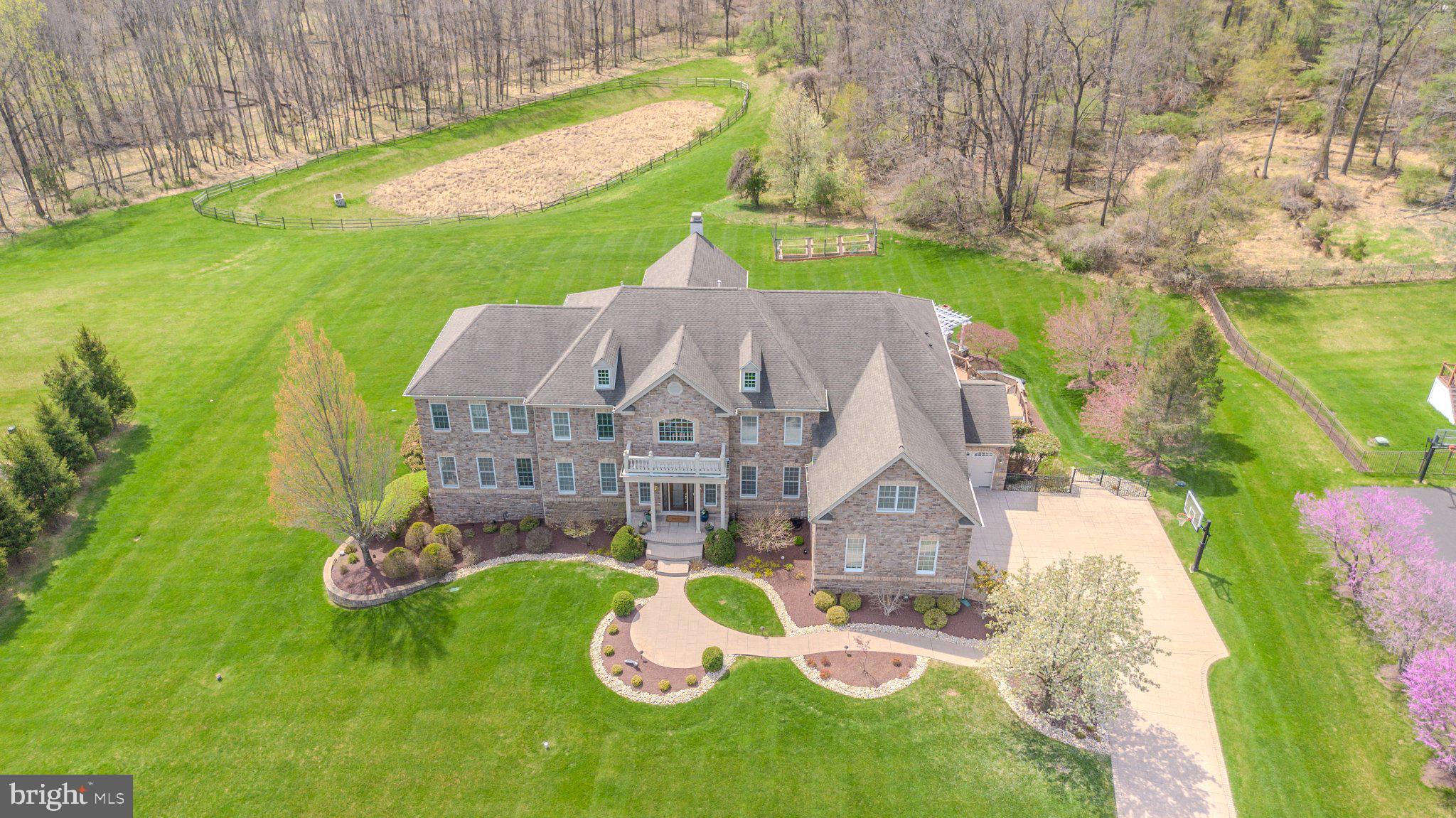 Experience unparalleled elegance in this custom-crafted estate in Upper Makefield’s premier Dutchess Farm Estates. Bathed in natural light and offering stunning sunset views, this residence blends meticulous craftsmanship with modern luxury. 

The open-concept main floor features a two-story family room and a gourmet chef’s kitchen with premium appliances. A rare main-floor guest suite and a sun-drenched conservatory add to the home’s versatility.

The second level is anchored by a massive owner’s retreat featuring a private gym and four additional en suite bedrooms. Storage is elevated by custom cabinetry and designer closets throughout. 

The finished walk-out lower level is an entertainer’s dream, boasting a full media room, a second high-end kitchen, and a 7th bedroom.

The exterior is a private resort featuring a covered patio, elegant pavilion, and a professional kitchen garden for "farm-to-table" living. 

Located in the award-winning Council Rock School District, with easy access to fine dining and boutique shopping. This is more than a home; it is a lifestyle.