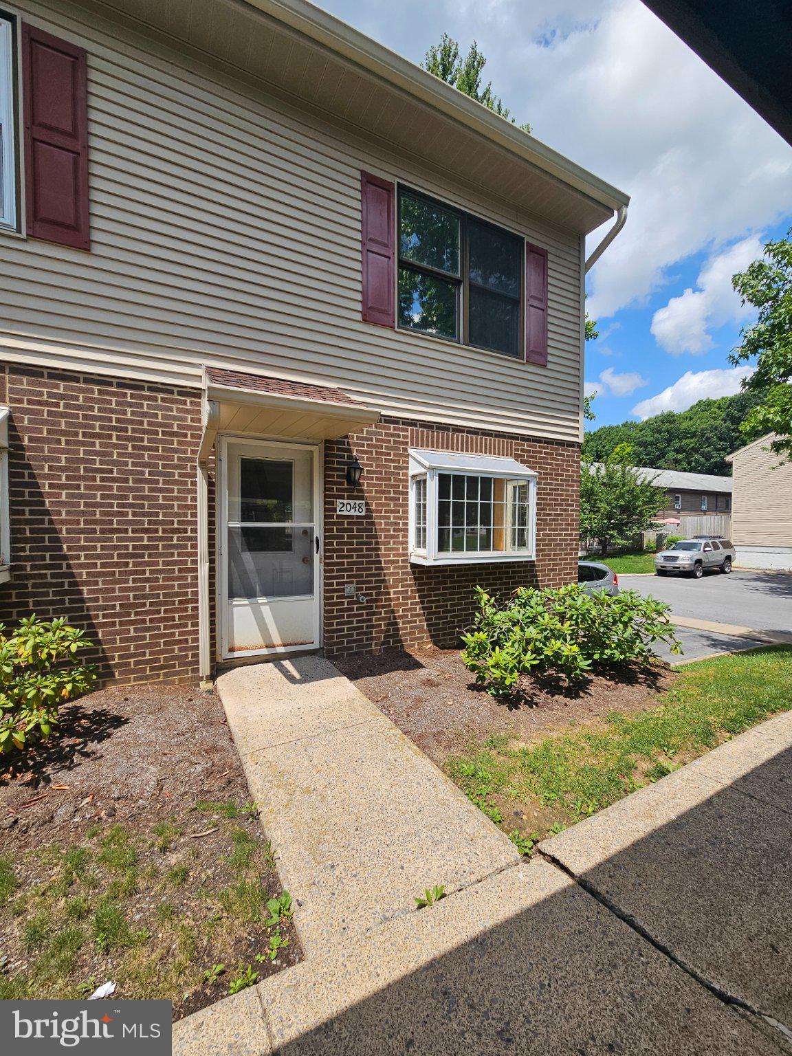 This charming end-of-row townhouse offers a blend of comfort and investment potential. With 1,024 sq. ft. , it features two spacious bedrooms and 1.5 bathrooms, ideal for maximizing rental income. The traditional architectural style, complemented by a brick front and vinyl siding, ensures low maintenance and lasting appeal. Inside, enjoy a cozy combination kitchen/dining area, perfect for entertaining. The eat-in kitchen is equipped with essential appliances, including a stove, dishwasher, and refrigerator, making it move-in ready for tenants. The unfinished full basement presents an opportunity for additional living space or storage, enhancing the property's value. A deck invites outdoor relaxation, while the detached carport adds convenience. The laundry chute and attic fan are thoughtful touches that elevate everyday living. This property not only provides a warm, inviting atmosphere but also promises strong rental returns in a desirable market. Don't miss the chance to invest in a home that feels like a retreat!