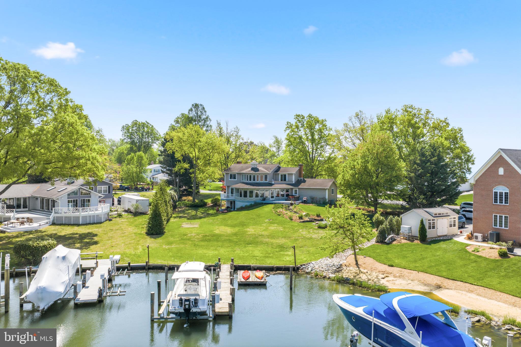 Price reduced!!!   Nestled along the banks of Watergate Harbor with direct access to the South River, in the prestigious Watergate neighborhood of Annapolis, 3712 Gateshead Drive offers the ultimate waterfront lifestyle with waterviews from every room in the home. When you enter the home you are greeted with the marble flooring in the foyer which transitions beautifully to the gleaming hardwood flooring throughout the main and upper level. As you enter the Living Room, natural light spills into the Bay Window while the wood burning fireplace is the focal point of the room. Next you enter the gorgeous waterfront Living Room with a private deck overlooking the Harbor plus views of the South River. The heart of the home is a gourmet kitchen adorned with sleek upgraded countertops and elegant glass-front cabinets. Recent updates in the kitchen include new GE Profile cooktop in 2024, new GE Profile oven and microwave in 2025 and new Kenmore Elite refrigerator in 2020. The open floor plan of kitchen provides a large island, kitchen table space and direct access to the Family Room. The Family Room offers the second wood burning fireplace on the main level and sliders to your waterfront deck. Journey upstairs when you will find 3 large guest rooms as well as the primary. The first bedroom will be the envy of your guests with a deck overlooking the South River and multiple closets. The other two bedrooms offer hardwood flooring and waterviews of the South River. The primary suite is a true sanctuary with tons of windows to take in the views. The en suite bath features a granite double bowl vanity, separate shower and soaking tub designed to "soak in" the views. As mentioned, the home features a walkout basement which is exceedingly rare in waterfront homes and provides tons of natural light. The expansive rec room in the basement features a cozy wood burning fireplace and is perfect for entertaining or relaxing after a day on the bay. Walk outside to the backyard which is made for entertaining. The large composite deck leads to the path which takes you to the waterfront firepit. This stunning home boasts a private 46 foot pier with a new 10,000 lb boat lift and a floating pier for those looking for idyllic days spent on the water. And for all the gardeners out there, not only is it the second largest lot in the community it is definitely one of the prettiest with professional landscaping throughout. from Homestead Gardens. You won't know what to do with all of the storage this home offers from the pull down attic storage over the oversized two car garage to the huge storage room just outside of the basement walk out. Complete peace of mind with dual zone heat pumps complete with a propane booster. In addition to the private pier, the community of Watergate offers a community marina, dry moorings, basketball courts, and a sandy beach with fire pit, pavilion and playground. The community offers something for everyone with neighborhood events throughout the year!
This is more than a home- it's a gateway to a life of sophistication, comfort, and endless waterfront adventures.