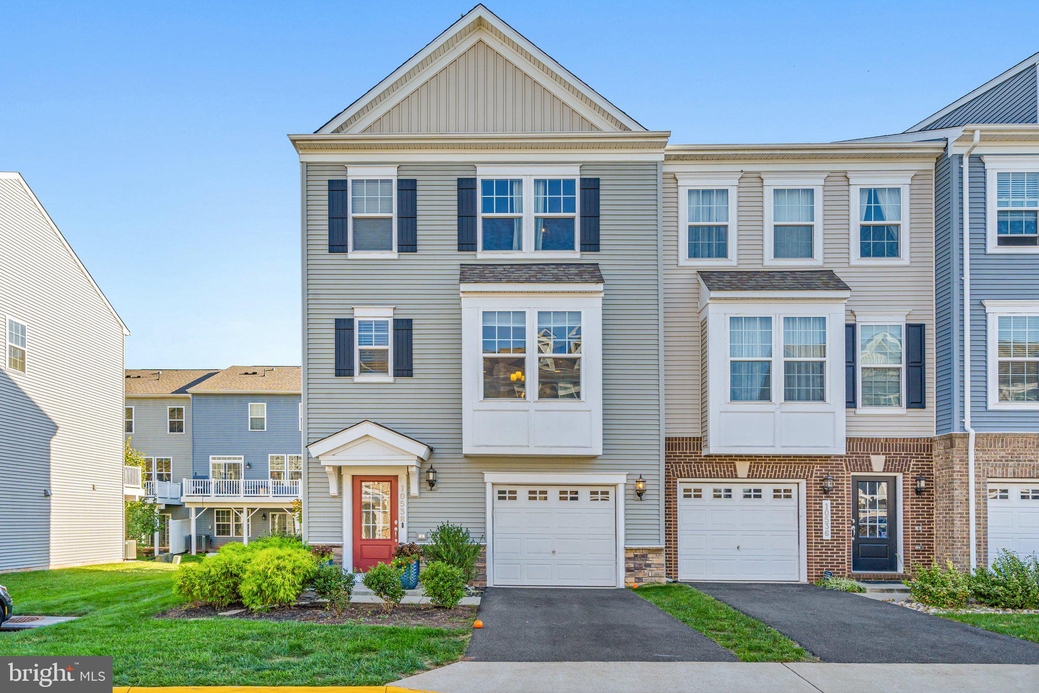 Nestled on a quiet street in the highly sought-after Bradley Square community, this beautifully maintained townhome offers both comfort and style. Step inside to an inviting, open-concept main level, bathed in natural light from expansive front-to-back windows. High ceilings and recessed lighting enhance the spacious feel, while the heart of the home—a gourmet kitchen—features sleek stainless steel appliances, modern brown cabinetry, quartz countertops with a stylish backsplash, and an oversized island perfect for both entertaining and casual family meals.

Upstairs, the luxurious primary suite boasts two walk-in closets and a spa-like en-suite bath with dual sinks, a private water closet, and an oversized shower with a built-in bench. Two additional bedrooms share a well-appointed hall bath, and the convenient upper-level laundry room makes daily living a breeze.

The lower level provides flexible living space with a cozy family room, sliding glass doors leading to the grassy backyard, and a full bath—perfect for a guest suite, home office, or recreation room. The attached garage, complete with an electric car charging outlet, adds extra convenience for modern living.

Bradley Square offers a range of community amenities, including tot lots, a splash pad, a scenic pond, green spaces, and walkable sidewalks. With lawn care, trash, and recycling services included in the low HOA fee, maintenance is easy.

Located just minutes from historic downtown Manassas, you’ll enjoy an array of restaurants, shopping, and year-round activities such as live music at the Harris Pavilion, farmers markets, and First Fridays—where the streets close for pedestrian-friendly festivals. Commuting is a breeze with the nearby Virginia Railway Express (VRE) and major routes like 234, 28, and I-66.

This townhouse has it all—don’t miss your chance to make it yours!