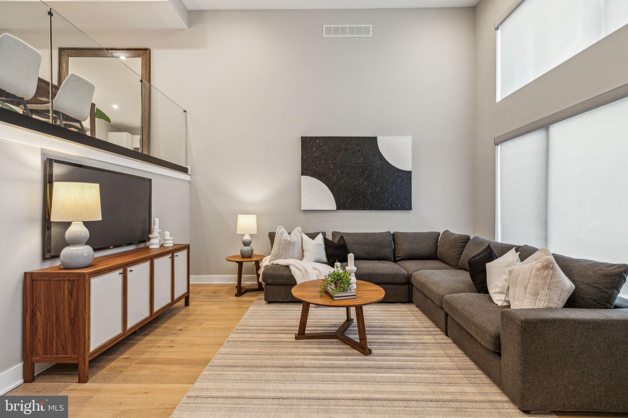 Extra- wide modern townhouse in the sought-after Graduate Hospital neighborhood featuring 4
bedrooms, 3.5 bathrooms, 2 car parking, a finished basement, and 2 outdoor spaces including a
roof deck with unmatched views of Philadelphia. Located in the Marian Anderson Neighborhood
Academy catchment, (formerly Chester Arthur) this home boasts 3,200 bright and airy, well laid
out square feet. As you walk down League Street, a quiet and neighborly block, you will
immediately notice the home’s handsome façade and large front windows which allow light to
pour in. Once inside, you will be taken by the 15 foot ceilings in the living room, as well as the
open stairs and the glass wall to the dining area, which offer an unparalleled open feel. The
generous kitchen features an oversized quartz center island, ample cabinetry including a pantry,
tile backsplash, stainless steel Bosch appliances, including a double wall oven, 5 burner gas
stove, a hood range and drawer microwave. A full wall of windows in the kitchen overlooks the
deck that extends 8 feet, making it ideal for your grill and a table for dining al fresco. A
convenient powder room caps off this level of the home. The second floor has two sizeable
bedrooms, both with excellent custom closets, as well as a full bathroom with a combination tub
and shower, double vanity and linen storage. Also conveniently located on this floor is a laundry
room which includes cabinetry and a sink. At the top of the stairs to the fourth floor you will be
greeted by a wet bar with sink, beverage fridge and ample storage. The primary suite can easily
accommodate a king-sized bed, has a walk-in closet with custom closet system, and a
bathroom featuring a double vanity, walk-in shower, and heated floors. Currently set up as a
home office with murphy bed, this guest suite will have your friends lining up to visit with its
comfortable accommodations and its own spa-like bathroom. The roof deck, with its green roof
finishes, boasts panoramic views including an unobstructed view of the skyline. Not to be
forgotten is the finished lower level, with custom built-ins and heated floors, which makes for the
perfect den, playroom, office or home gym – the possibilities are endless! The two-car side-by-
side parking, with EV hookup and ample custom storage, is truly priceless. Equipped with all the
bells and whistles that newer construction offers, this home has dual-zone HVAC with Nest
thermostats, a tankless water heater, Pella windows, Ring cameras, and more. Located near
neighborhood favorites like Breezy’s Deli, Porcos, Small Oven Bake Shop, Los Camaradas, Ultimo
Coffee, and Sidecar Bar. Convenient to the new Aldi and CVS, plus Heirloom, Sprouts, Target, Starbucks and Wawa, makes running errands a breeze. Not only is this home in one of the best locations in Graduate,
but there are 6 years remaining on the tax abatement!