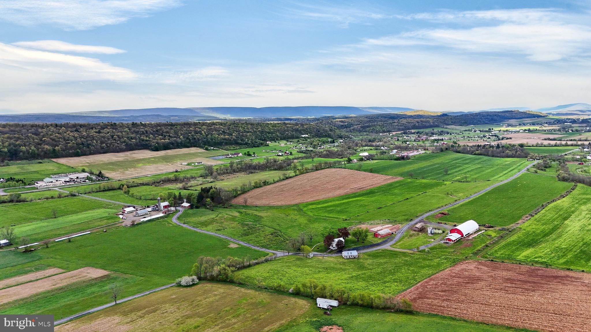 **This property will be offered at Public Auction on June 27, 2026 @ 10:00 AM. The listing price is the suggested opening bid only and in no way reflects the final sales price. $85,000 Deposit due on auction date. 2% transfer tax to be paid by the purchaser. Settlement on or before August 21, 2026.**Exceptional opportunity to own a turnkey 127-acre certified organic farm in Juniata County featuring a beautifully remodeled farmhouse, productive agricultural infrastructure, and multiple income possibilities. The fully furnished home was completely renovated in 2023 and is currently operating as a successful Airbnb, offering 3 bedrooms, 2 full baths, a spacious primary suite with jacuzzi tub, radiant floor heat throughout, custom kitchen with bar seating, and a bright living room with sliding doors opening to an outdoor deck with stunning countryside views. This working farm is well-equipped for dairy or livestock operations with a 50’ x 150’ free stall barn, double-8 milking parlor, milk house with office, manure pit, feed storage bins, and expansive grazing pastures. Additional outbuildings include equipment and storage buildings, barn/shop space, and garage storage for maximum flexibility. The land offers level to gently rolling certified organic tillable acreage, subdivision potential, solar lease opportunities, 7 acres of woodland, a scenic creek, and established hunting tree stands. A rare investment combining agricultural productivity, recreational appeal, and proven rental income in one impressive package.