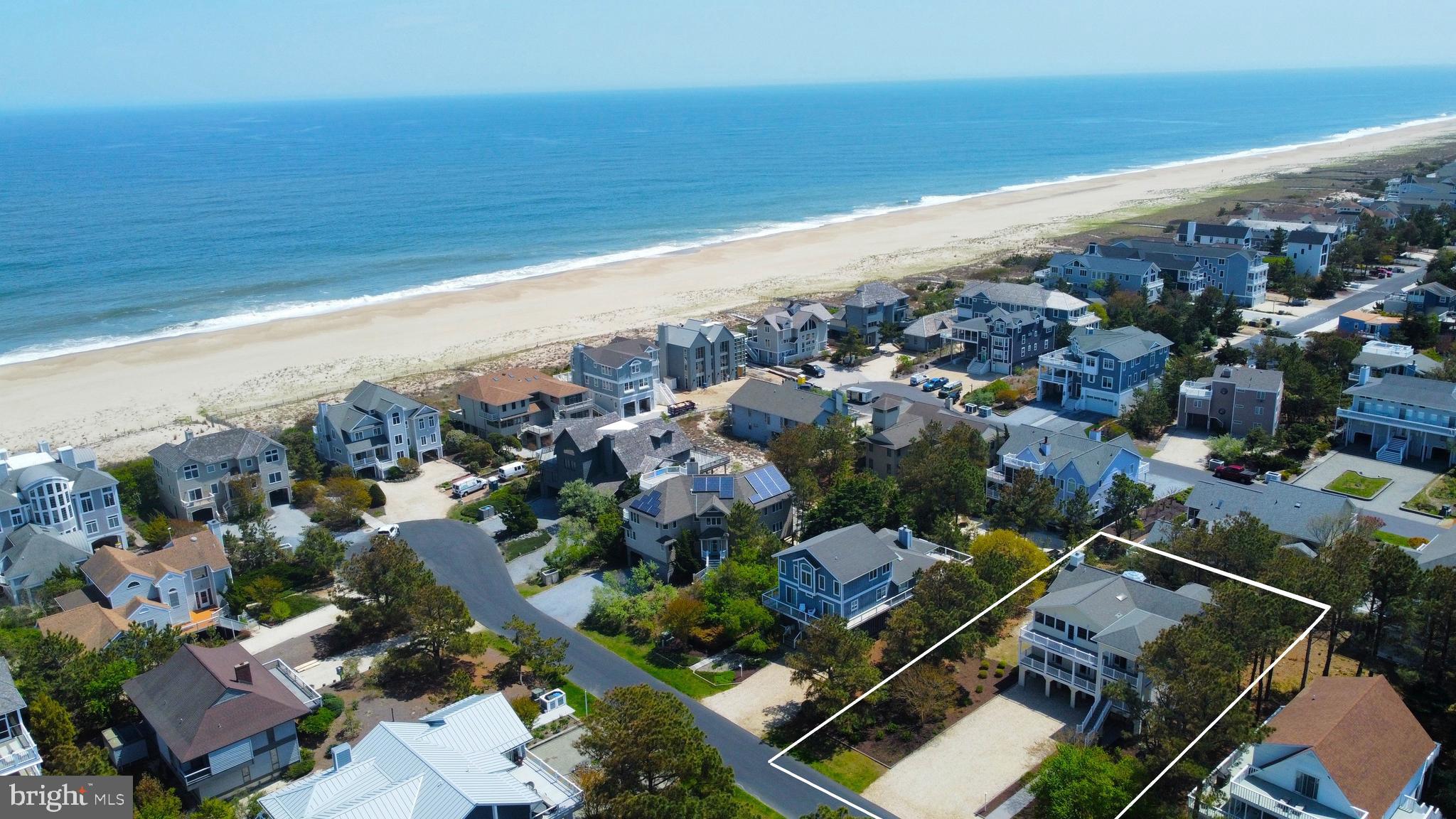 Exceptional Oceanside retreat just steps from the shoreline in a private, life guarded North Bethany community. Thoughtfully expanded by the well-known architectural firm Barnes Vanze, this spacious home offers large gathering areas, abundant natural light, and effortless indoor-outdoor living. An elevator provides easy access to the top floor, where a stunning great room with soaring ceilings seamlessly connects the gourmet kitchen, dining area, and living space. Ideal for entertaining family and friends, this level opens to both a large, screened porch and an expansive sun deck offering a peek of the ocean. The kitchen is beautifully appointed with crisp white cabinetry, granite countertops, tiled backsplash, stainless steel appliances, a center island, and a butler’s pantry with an additional sink, refrigerator, and cabinetry. Also on the top level is a large office with custom built-ins, a versatile flex room that could be the 6th bedroom, but is currently used as a family room with easy access to this level's full bath. The lower level features a spacious primary suite with an ensuite bath complete with dual vanities and a large glass-enclosed shower. Four additional generously sized bedrooms and three additional full baths provide ample space for family and guests. The ground level offers two conditioned storage areas, an outdoor shower, covered parking with easy access to the elevator's entry and plenty of additional driveway parking. This home was meticulously maintained by one owner, and although never rented, it offers excellent potential as an investment property. Conveying fully furnished and situated on a large parcel in a desirable North Bethany location just minutes from the shops and dining of downtown Bethany Beach, this exceptional property is ready to be enjoyed for generations to come.