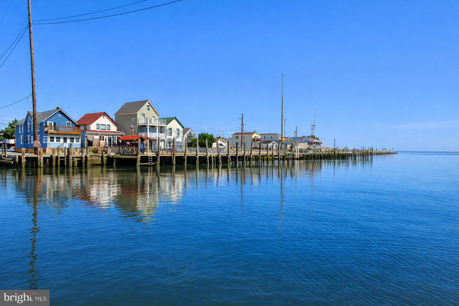 Become the ENVY of all your family and friends! Enjoy the ease of single-level living with a blank canvas ready for your imagination. Tucked away from the hustle and bustle, this waterfront gem offers a rare opportunity to create the coastal getaway you’ve always envisioned. Renovations are already underway, giving you a head start to finish the home in your own personal style. With the potential for up to three bedrooms, the flexible layout can easily be customized to fit your needs.

A one-car garage adds everyday convenience, while the true highlight is the expansive wooden deck leading to a private dock with a charming covered porch—perfect for fishing, boating, crabbing, or simply relaxing while taking in the peaceful water views. Paddle your kayak across the river to JP’s Wharf or the popular Bayview Inn for great food and live music. Enjoy seasonal small-town celebrations in North Bowers and the welcoming local community.

Ideally located with great investment potential, this property is just minutes from DE Turf Sports Complex and a short drive to Milford for shopping, dining, pubs, and farmers markets. Conveniently situated for easy trips to Lewes, Rehoboth Beach, Dewey Beach, and Ocean City.

Whether you’re dreaming of a sleek modern retreat or a cozy beach bungalow, this property is filled with possibilities. Create your own slice of paradise in one of Delaware’s hidden coastal communities. Property is being sold as-is.   Exterior photos have been enhanced by Chatgpt to show a sunny day.