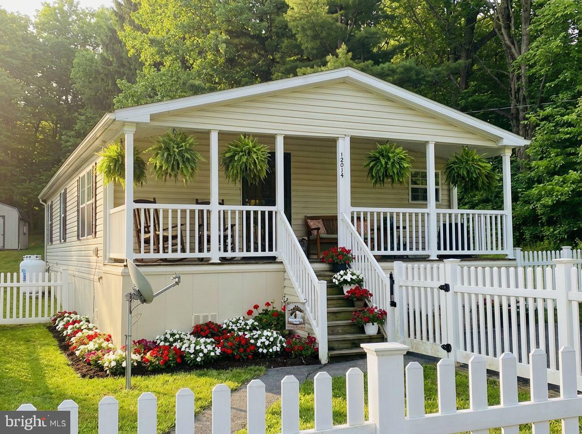 Dreamed of life behind a white picket fence? This one-story, 3 bedroom / 2 bathroom home in a peaceful rural setting with tree-lined views, might be the one.

Step onto the welcoming front porch—perfect for evenings with a glass of tea and a good book—and enjoy the enclosed front yard with white vinyl fencing and a handy storage shed. Inside, an open floor plan connects the living, dining and kitchen areas, all finished with newly installed luxury vinyl plank flooring. Cozy up by the living room fireplace beneath soaring cathedral ceilings. Practical touches include main-level laundry, a ramp to the side exterior door, a whole-house generator, and a primary ensuite with a handicap tub.

Comfort, convenience, and charm—this home has so much to offer. Call today to schedule your tour!!!

*** Some images are AI-generated/virtually staged for illustration purposes only. Please tour the property in person to verify actual condition.