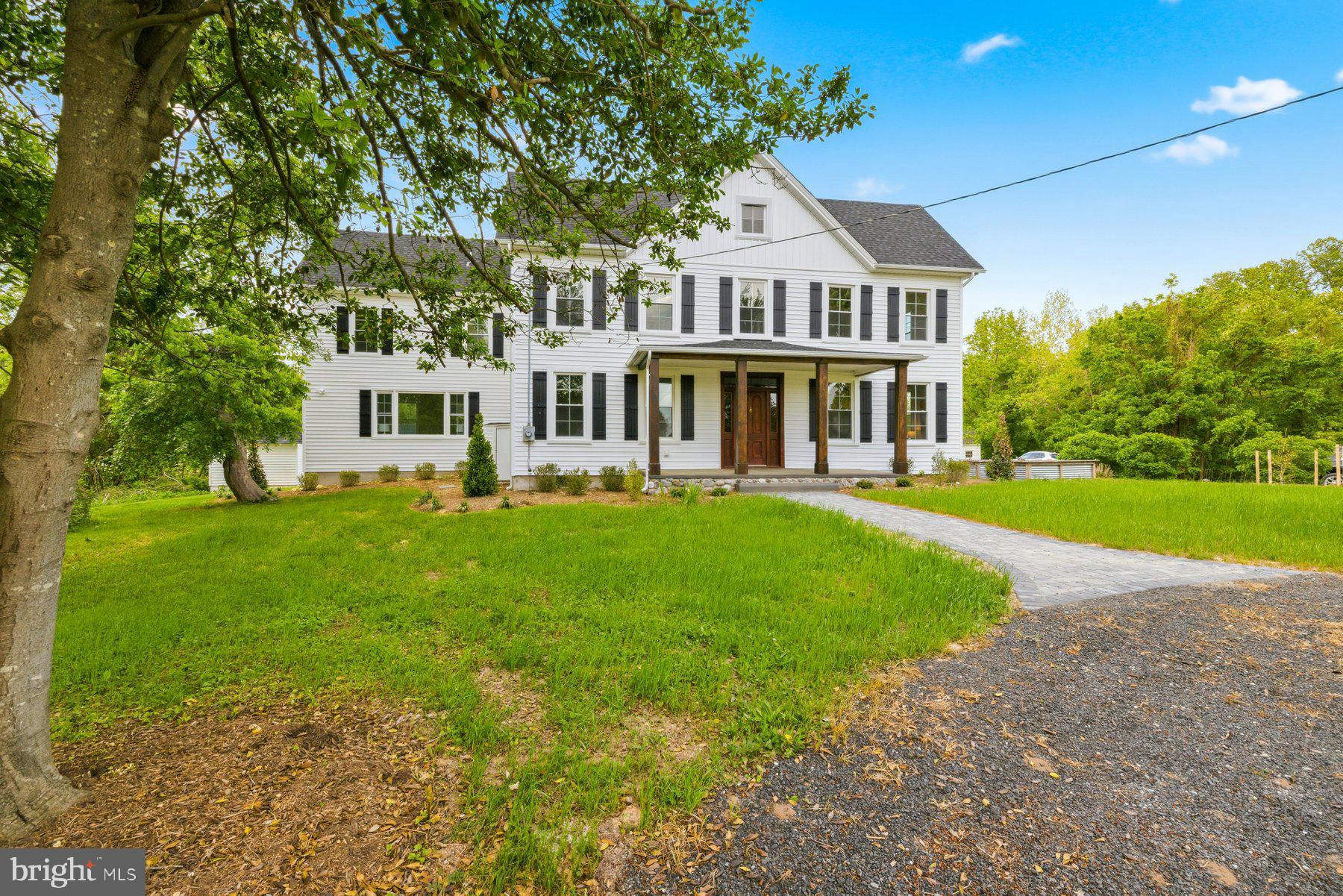 Modern Wine Country Estate in Brandywine — where historic charm meets refined modern living... Set along a cedar-lined driveway and surrounded by open, usable farmland, this beautifully restored farmhouse blends timeless character with thoughtful upgrades throughout. Inside, 9.5-foot ceilings, intentional lighting design, and rich hardwood floors — original where preserved and newly added where needed — create a warm, elevated feel from the moment you enter... Carefully selected tilework throughout the home bridges old and new, pairing classic patterns with modern finishes to honor the home’s heritage while delivering a fresh, elegant aesthetic... The restored original front door opens to a stunning interior highlighted by a true showpiece staircase and an airy main level accented by subtle industrial touches, including exposed ductwork that adds character without sacrificing comfort... The functional chef’s kitchen features GE Café appliances and flows seamlessly into a spacious family room with custom trim and a fireplace, perfect for gathering and everyday living... Four large bedrooms include a main-level primary suite plus a second primary or guest suite upstairs, offering flexibility for multigenerational living or extended stays... Recent improvements include new windows, siding, roof, gutters, and HVAC — delivering peace of mind alongside curated design. Outside, a front horseshoe driveway and stone paver walkway lead to the welcoming front porch, while the surrounding farmland provides privacy, open views, and endless possibilities... Extensive professional landscaping adorn the property and grounds... Perfectly positioned along the Legacy Wine Trail and just minutes from multiple local wineries, this property offers a true lifestyle setting while remaining only 10–15 minutes from shopping, dining, and everyday conveniences... With easy access for commuting into DC and Northern Virginia, this is a rare opportunity to enjoy modern farmhouse living with space, style, and connection to the region’s growing wine country.