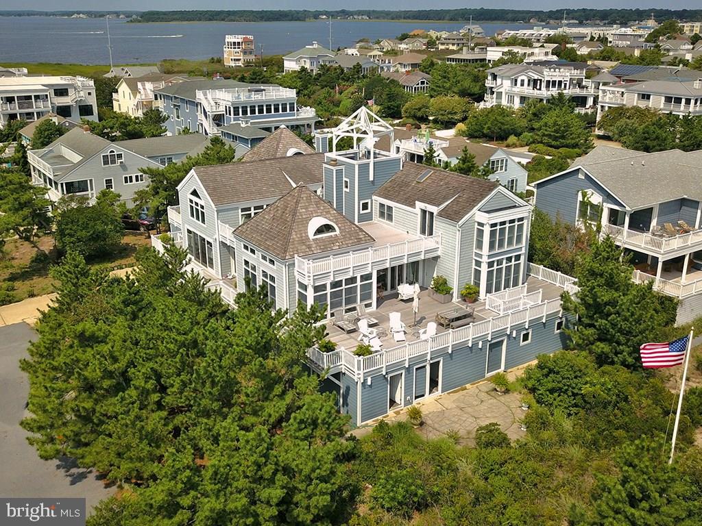 Being sold at lot value! Enjoy panoramic ocean views and breezes from every corner of this amazing oceanfront home, situated on an oversized 100 x 150 lot. 1 Hazlett Avenue features 6 bedrooms, 5 full baths, 2 half baths, a sprawling floor plan perfect for entertaining, gourmet kitchen, multiple living spaces, vaulted ceilings, gorgeous pine beams, custom trim and wood-burning fireplace. The second floor features a large master suite with sitting room (7th bedroom) and private oceanfront deck. The lower level includes 4 bedrooms, game room, gym, 2 car garage and an abundance of storage for beach toys. The exterior leaves little to be desired with wrap around decks, oversized spa, beautiful landscaping providing utmost privacy, the "bell tower" offering exquisite ocean sunrises and Rehoboth Bay sunsets and room for a pool. This home is being sold fully furnished.