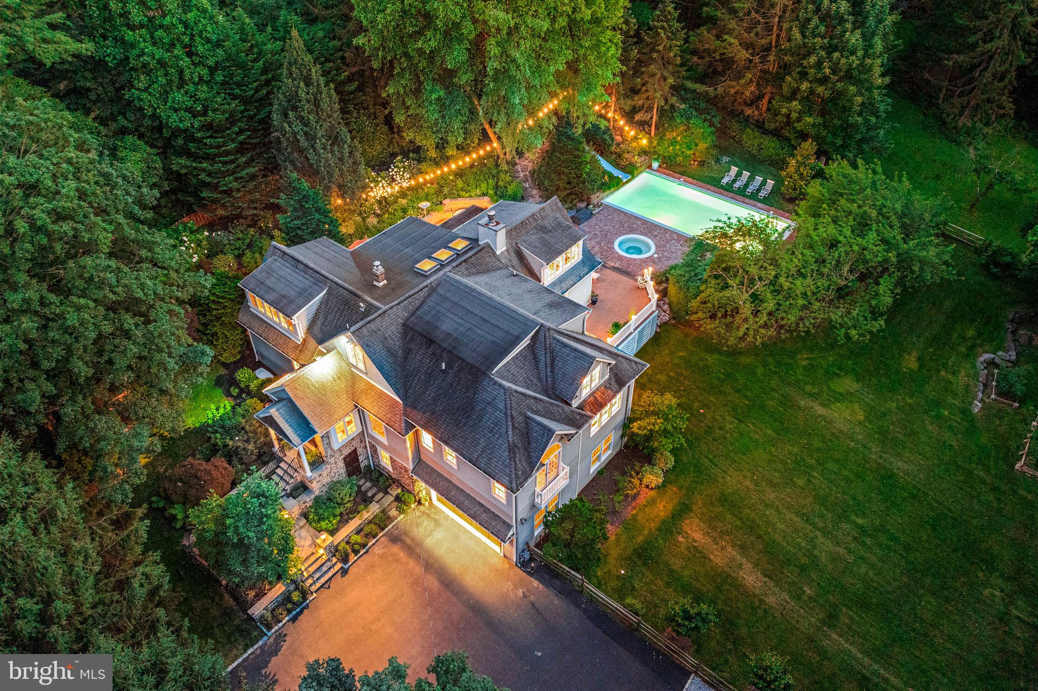 Private and sophisticated design define this beautiful Radnor home in the top-rated
Radnor School District. Offering just under 5000 sq ft of indoor/outdoor living on a private
acre lot, this 5 bedroom, 4.1 bath home is walkable to Radnor Elementary and High School and the Harford Dog Park. A carriage house from the early 1900’s, 185 Biddulph was reimagined and expanded by award-winning Gardner/Fox .  As a premier design-build firm, Gardner/Fox’s meticulous craftsmanship seamlessly blends historic character with modern luxury. This renovation totally transformed and enlarged the home, introducing luxury finishes, almost 10 foot ceilings, and abundant windows framing views of the saltwater pool, and hot tub while creating an effortless flow that leads to multiple outdoor living spaces including screened porch and patios. 
Exceptional curb appeal meets extensive stone hardscaping and stately front door framed by  handmade glass transoms. Inside you will find rich wood flooring, and deep-set windows offering gorgeous views from every room. The foyer leads to a Family Room with a wood-burning fireplace, opening to a spacious dining room with double French doors opening to a screened-in porch for a seamless entertaining flow. The David Stimmel-designed kitchen features custom Crystal cabinetry, tile backsplash, and a premium appliance suite: 6-burner Wolf range, 48” paneled Sub-Zero, Miele dishwasher, and GE Profile microwave. The center island includes a prep sink, Sub-Zero fridge drawers, and a butcher block inlay. An adjoining sun-drenched coffee nook/sitting room can easily accommodate a large dining table instead. From here, double French doors lead to a brick terrace with multiple seating and dining areas and a screened-in porch. This level also includes a sitting room with French doors to the pool, an office, a walk-in pantry, and a powder room.
The Main-Level Primary Suite is a sanctuary added during the Gardner/Fox expansion, with high ceilings, gorgeous views, and French doors to a private balcony overlooking the grounds. The suite includes a walk-in closet outfitted by California Closets and a bathroom with double vanities, soaking tub, seamless glass shower, and private water closet. Off the Family Room, a staircase leads to the upper-level, also part of the Gardner/Fox renovation. At the top of the stairs is a spacious bonus room—a sun-drenched hangout space with overhead skylights and a built-in partition for versatile use, including as an additional bedroom. This floor includes three additional large bedrooms with custom built-ins—including a spacious Ensuite bedroom with its own bath—and a well-appointed hall bath with double vanities.
The finished Ground Level is entirely above grade and provides a flexible living area updated with durable LVP flooring. Serving as the home’s original main entrance, this level features a large home gym (or 5th bedroom/playroom), a full bath with a seamless shower door, and a spacious laundry room with custom cabinetry. An entry with a built-in bench accesses the double-deep, 2-car garage with significant storage.
The landscaped grounds offer abundant room to relax on the large grassy areas, deck, or patio.
The exterior is a private oasis featuring a saltwater pool with a slide, electric safety cover, and a
well tended garden with mature plantings. The Springhouse and under-house shed provide storage. This premier location is less than a mile from the Radnor Train Station with service to Philadelphia and NYC.
Enjoy a unique lifestyle with walkability to the train, Radnor Elementary and High School, and the Harford dog park. Conveniently located near I-476, Route 30, and multiple corporate centers, with the dining and shopping of Wayne, Radnor, Villanova, and King of Prussia all close by. This home offers a sophisticated, move-in-ready lifestyle with a serene setting in an unbeatable Radnor location.
